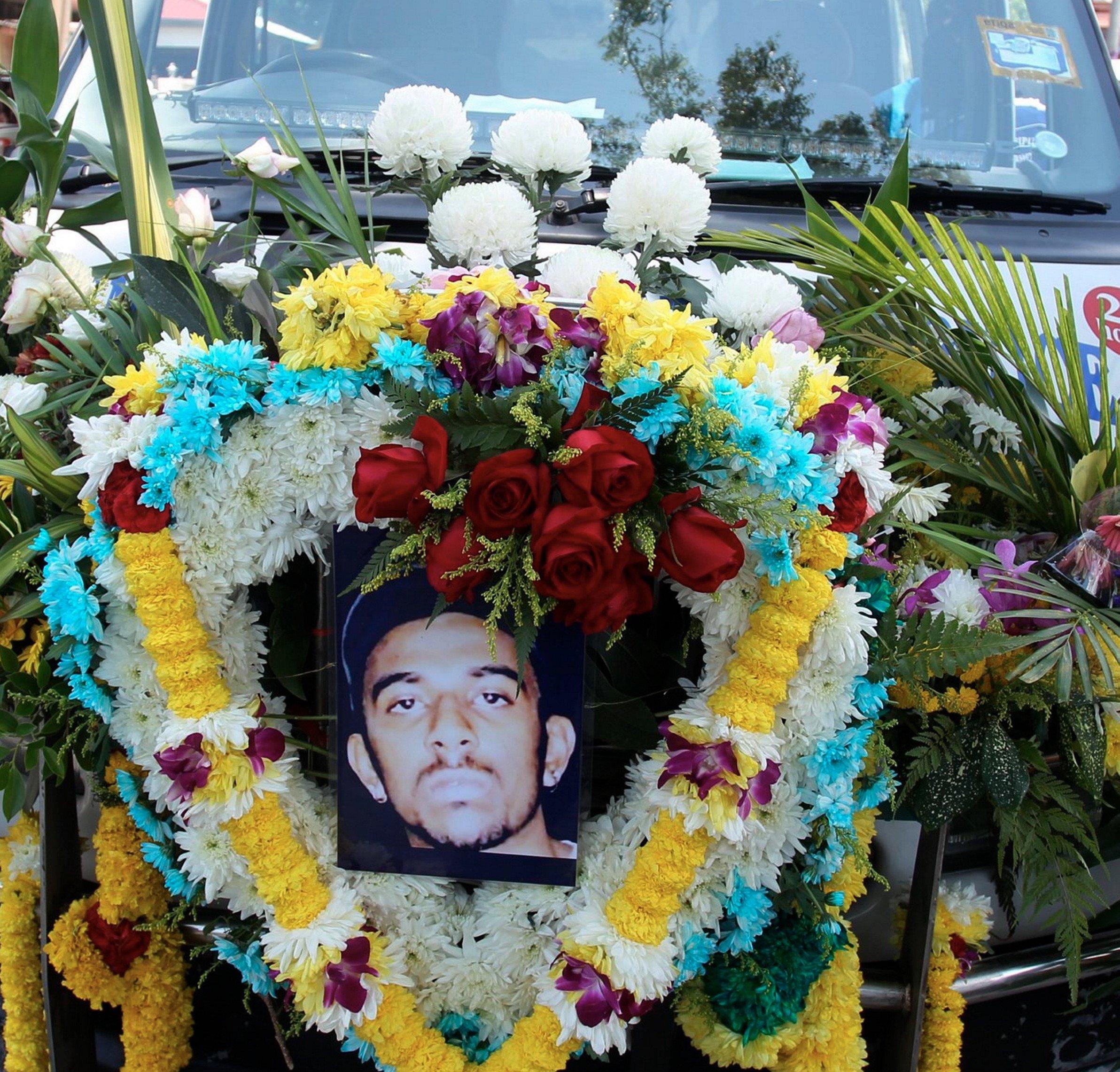 The coffin of Nagaenthran K Dharmalingam is carried in a hearse at his funeral in Tanjung Rambutan, Perak, today. Photo: Bernama