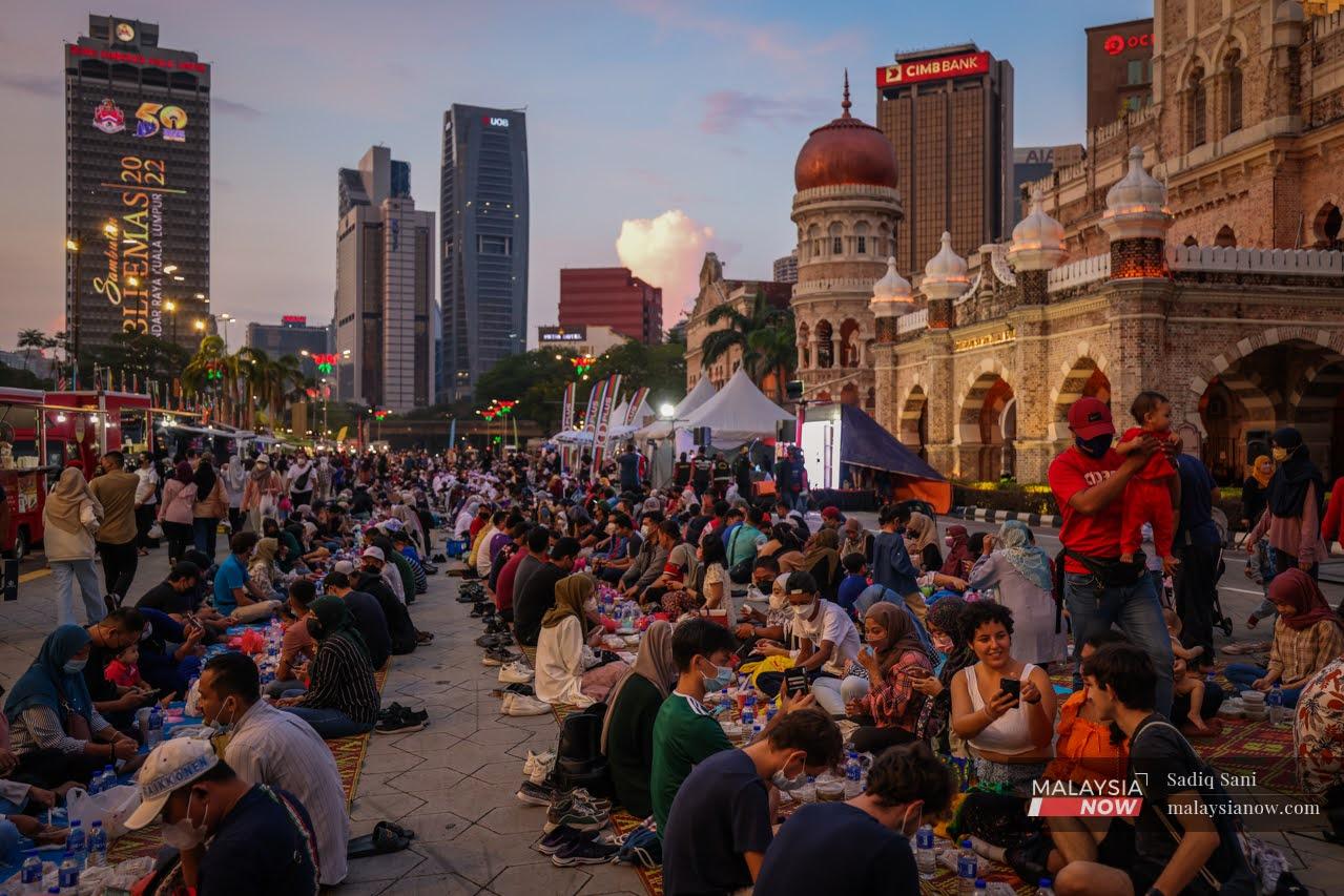 People gather to break their fast outside the Sultan Abdul Samad building at Dataran Merdeka, Kuala Lumpur.