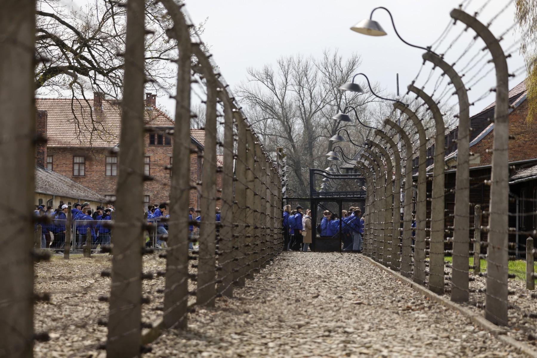 Participants walk past fences of the former Auschwitz-Birkenau camp during The March of the Living to honour the victims of the Holocaust, at the site of the Memorial and Museum Auschwitz-Birkenau in Oswiecim, Poland on April 28. Photo: AFP