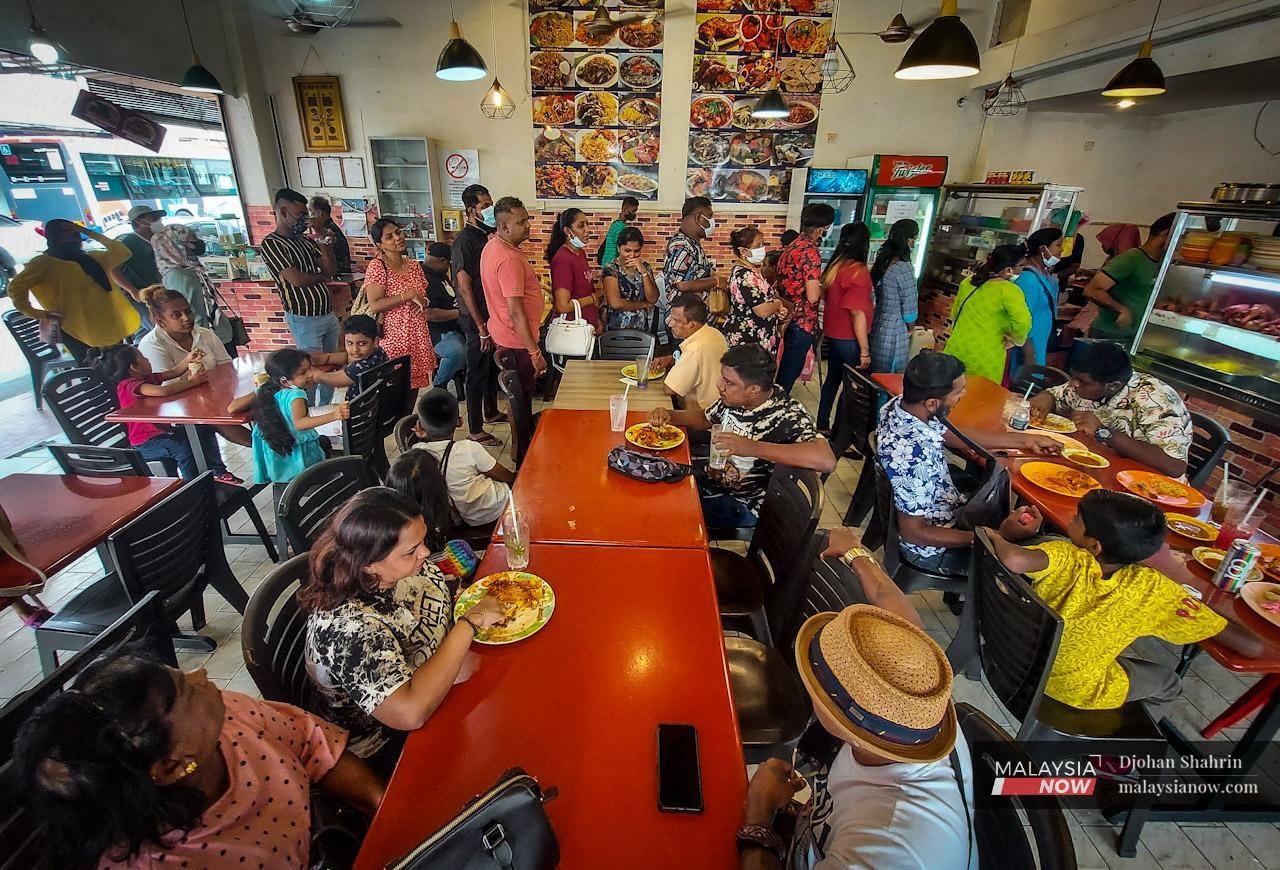 Customers queue at a nasi kandar restaurant in Lebuh Chulia, George Town in Penang.
