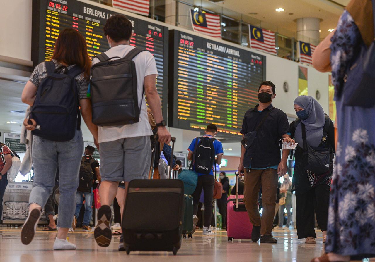 Travellers returning from their home towns after the Hari Raya break make their way through the South Integrated Terminal in Kuala Lumpur yesterday. Photo: Bernama