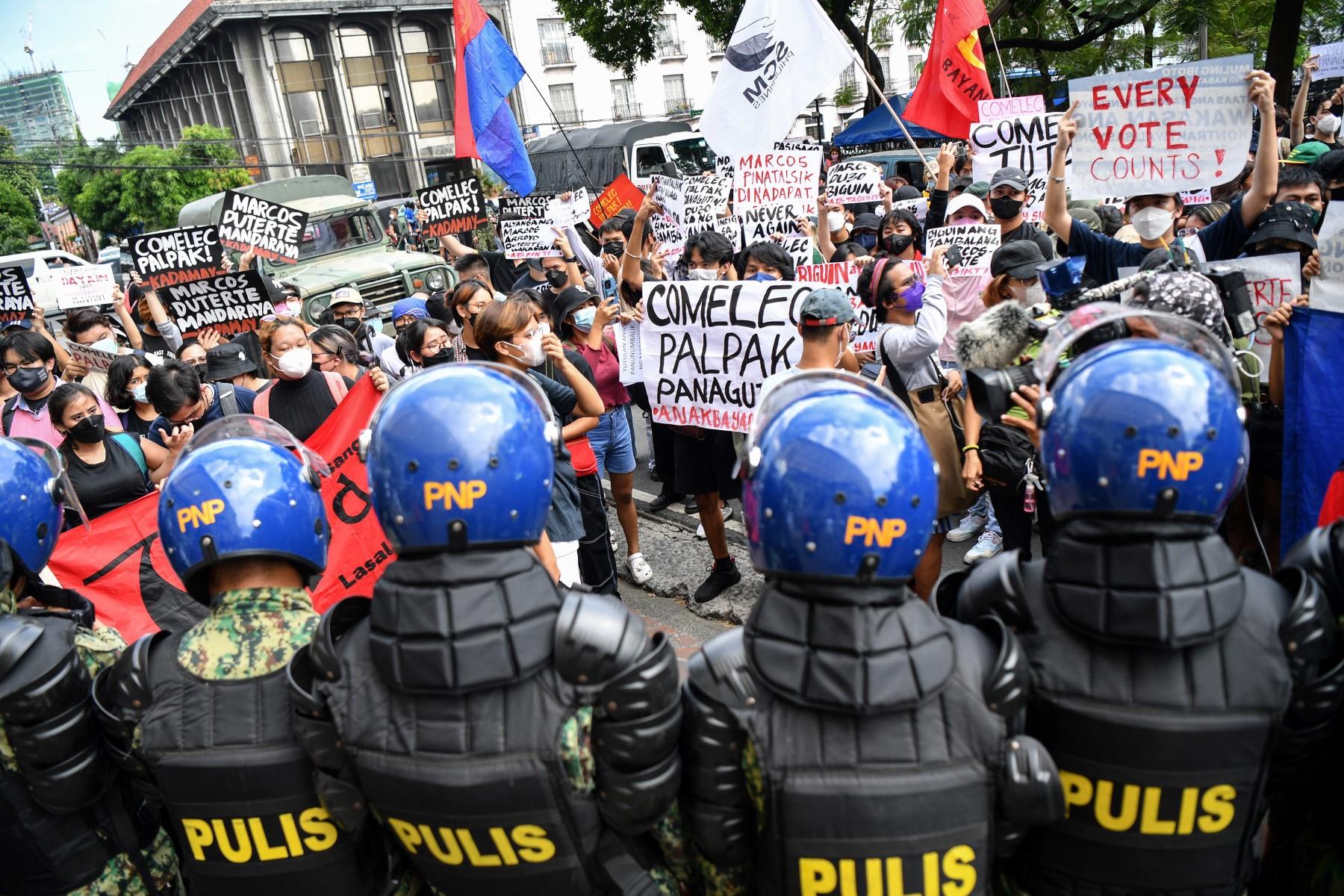 People display placards during a rally in front of the commission on elections in Manila on May 10, to protest against the results of the May 9 presidential election. Photo: AFP