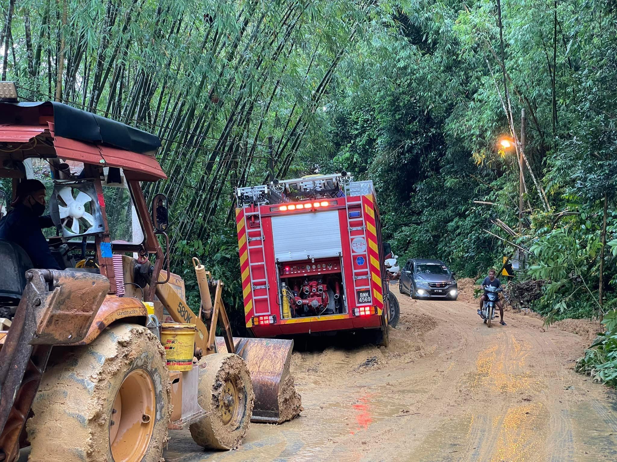 Heavy machinery is used to clear a road following flash floods and landslides in several areas in Bentong this morning. Photo: Facebook
