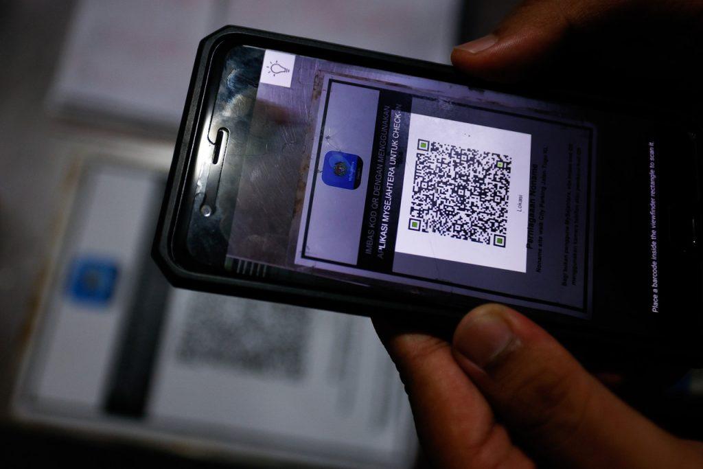 Customers at pubs and night clubs must still register with MySejahtera although use of the application has been largely discarded since May 1. Photo: Bernama