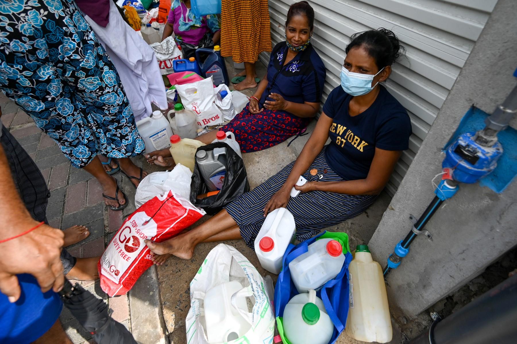 People queue up to buy kerosine for domestic use at a supply station after authorities relaxed the ongoing curfew for a few hours in Colombo on May 12. Photo: AFP