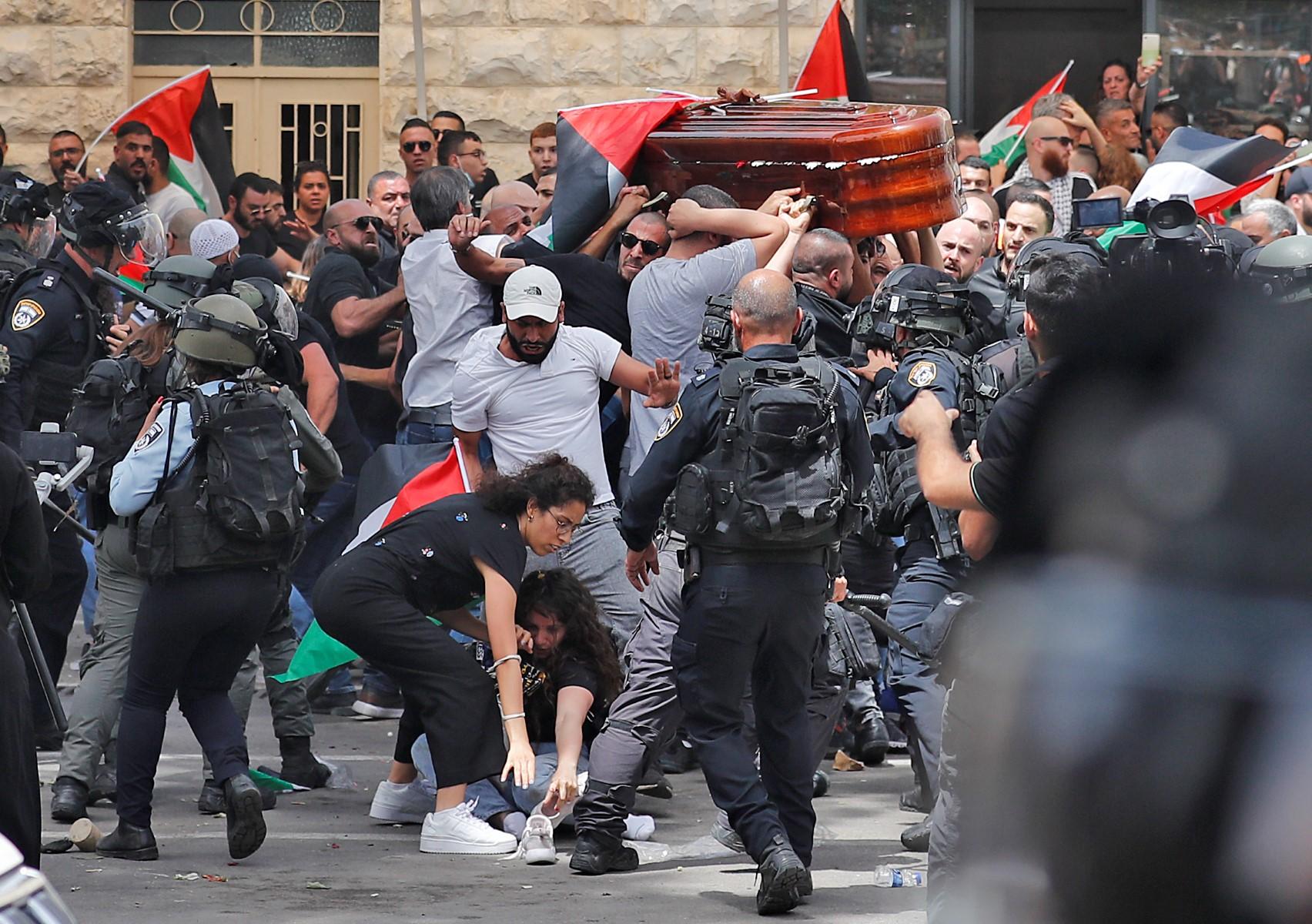 Violence erupts between Israeli security forces and Palestinian mourners carrying the casket of slain Al Jazeera journalist Shireen Abu Akleh out of a hospital, before being transported to a church and then her resting place, in Jerusalem, on May 13. Photo: AFP