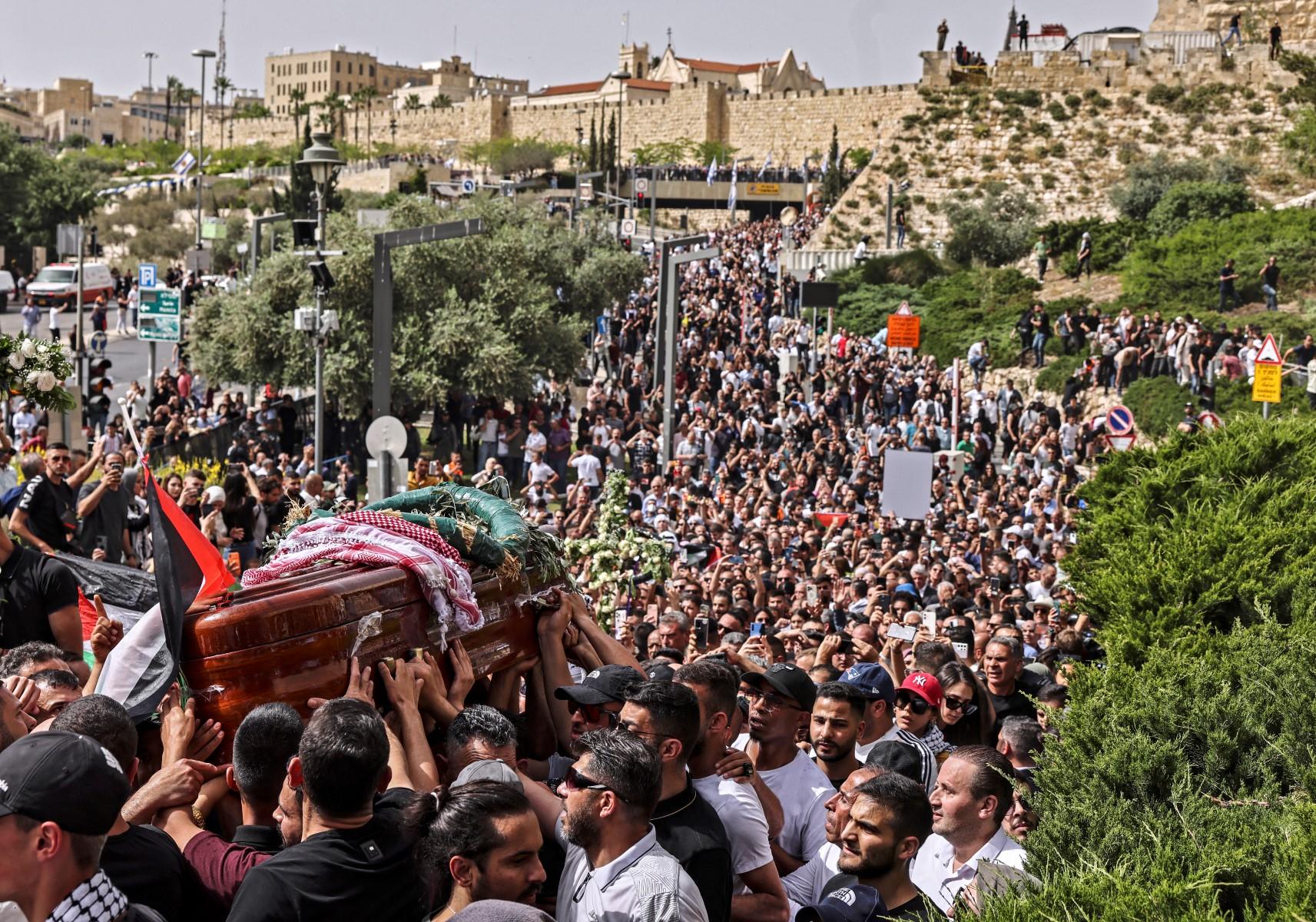 Palestinian mourners carry the casket of slain Al Jazeera journalist Shireen Abu Akleh from the church towards the cemetary, during her funeral procession in Jerusalem, on May 13. Photo: AFP