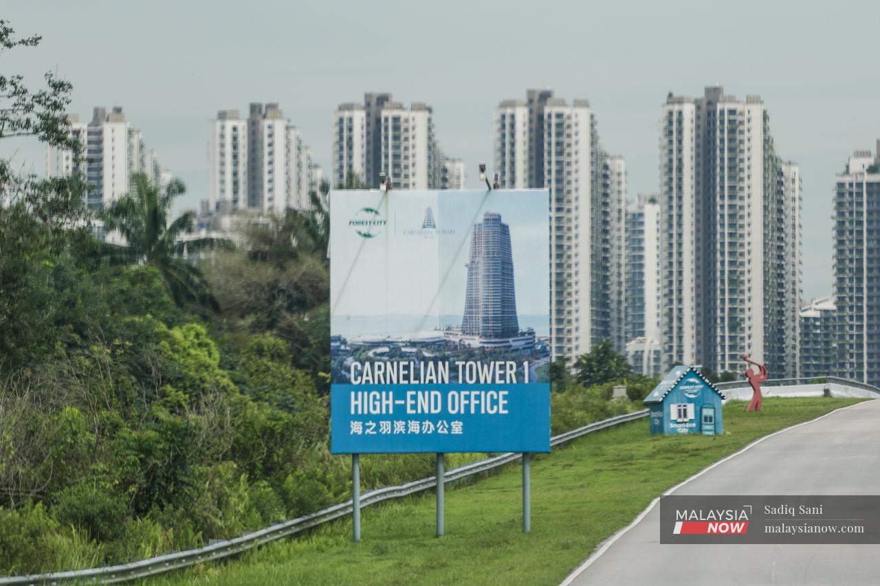 Office blocks are advertised on a signboard along a highway heading towards Forest City. The project had largely targeted Chinese nationals who, it was hoped, would make the area their second home.