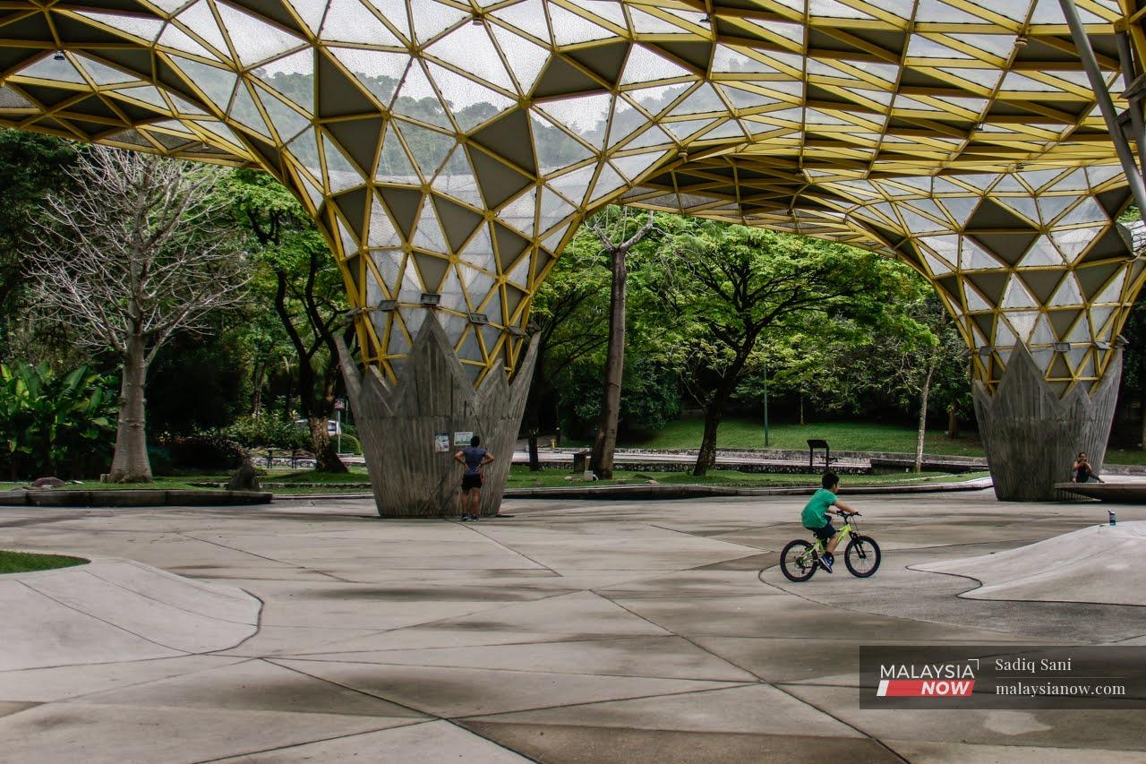 A child rides his bicycle at the Perdana Botanical Garden in Kuala Lumpur.