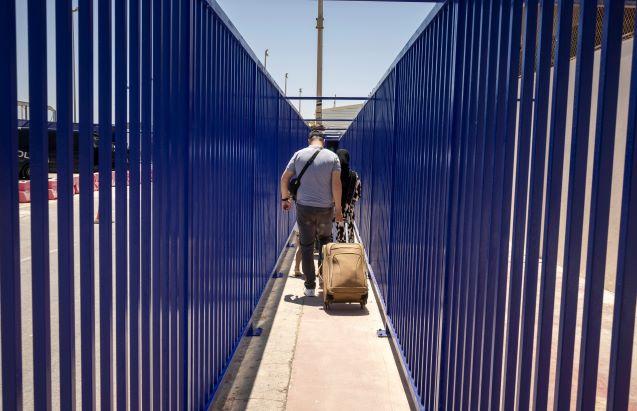 Travelers arrive to the border crossing in the Spanish enclave of Ceuta on their way to Morocco, on May 17. Photo: AFP