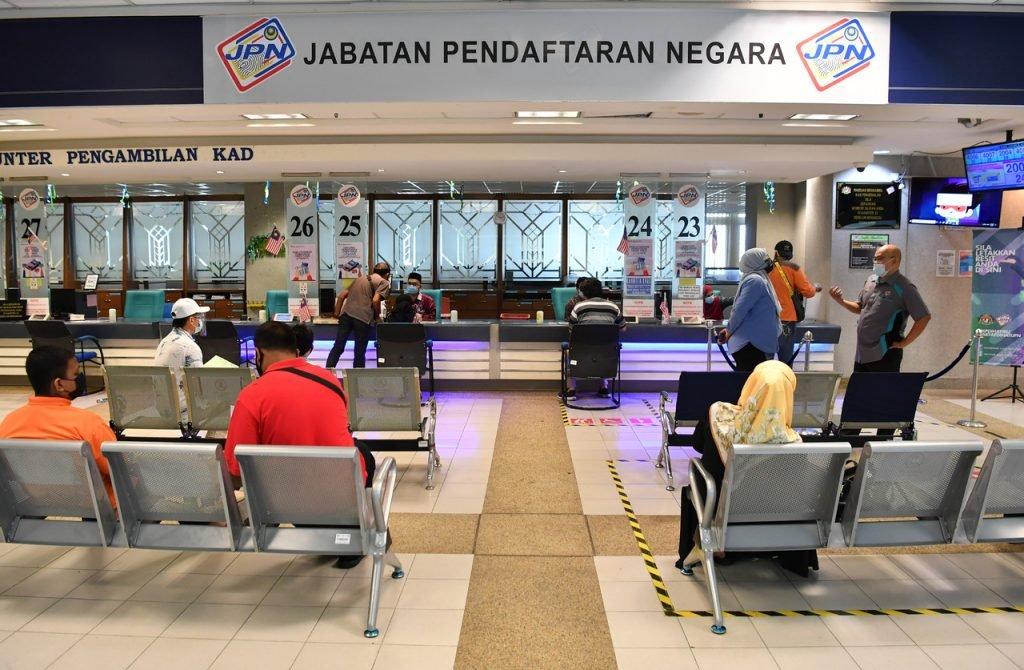 Members of the public wait at the National Registration Department in Putrajaya, in this file picture. Photo: Bernama