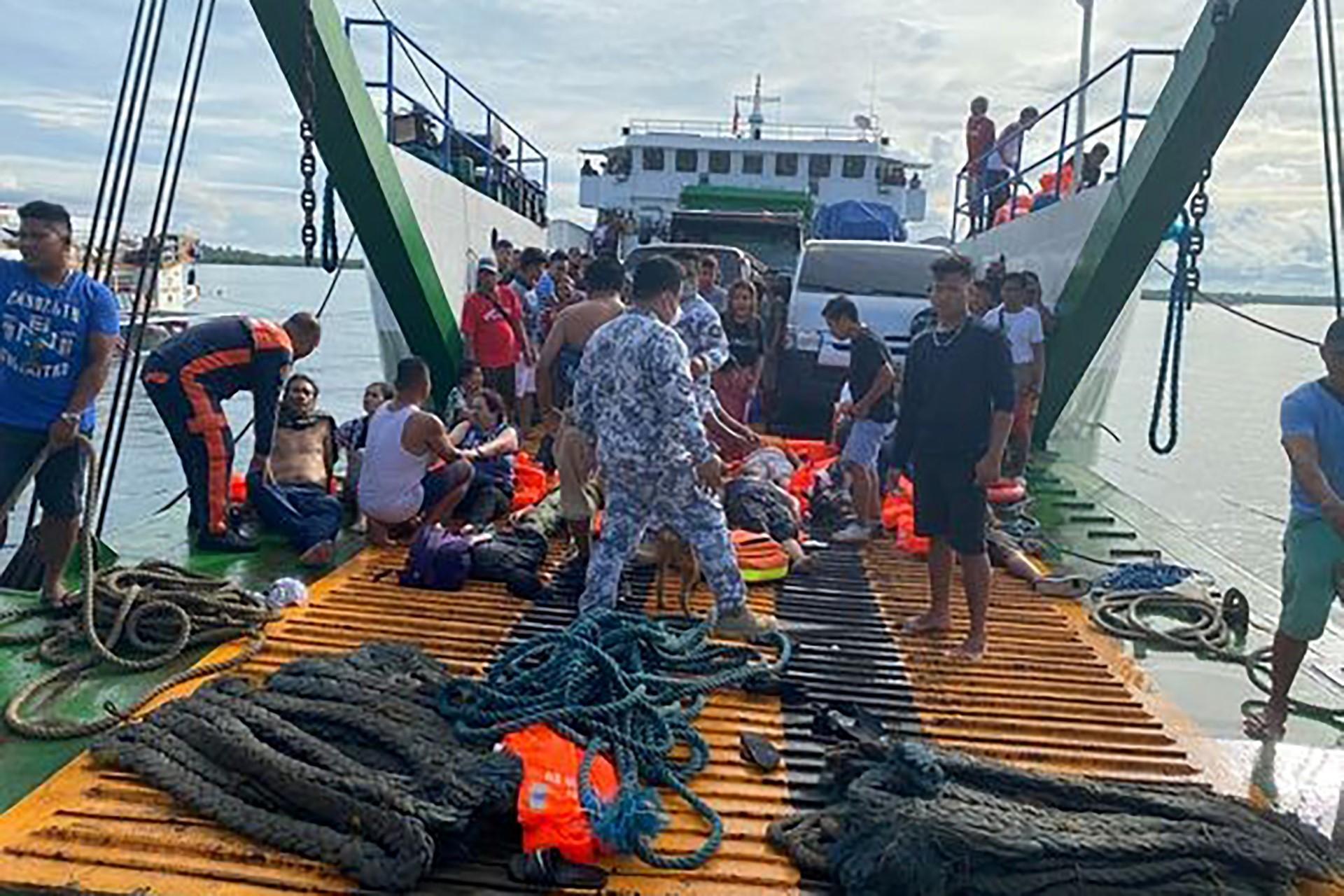 This handout photo taken and released on May 23, from the Philippine Coastguard shows rescued ferry passengers sitting onboard another ferry off Real town, Quezon province. Photo: AFP