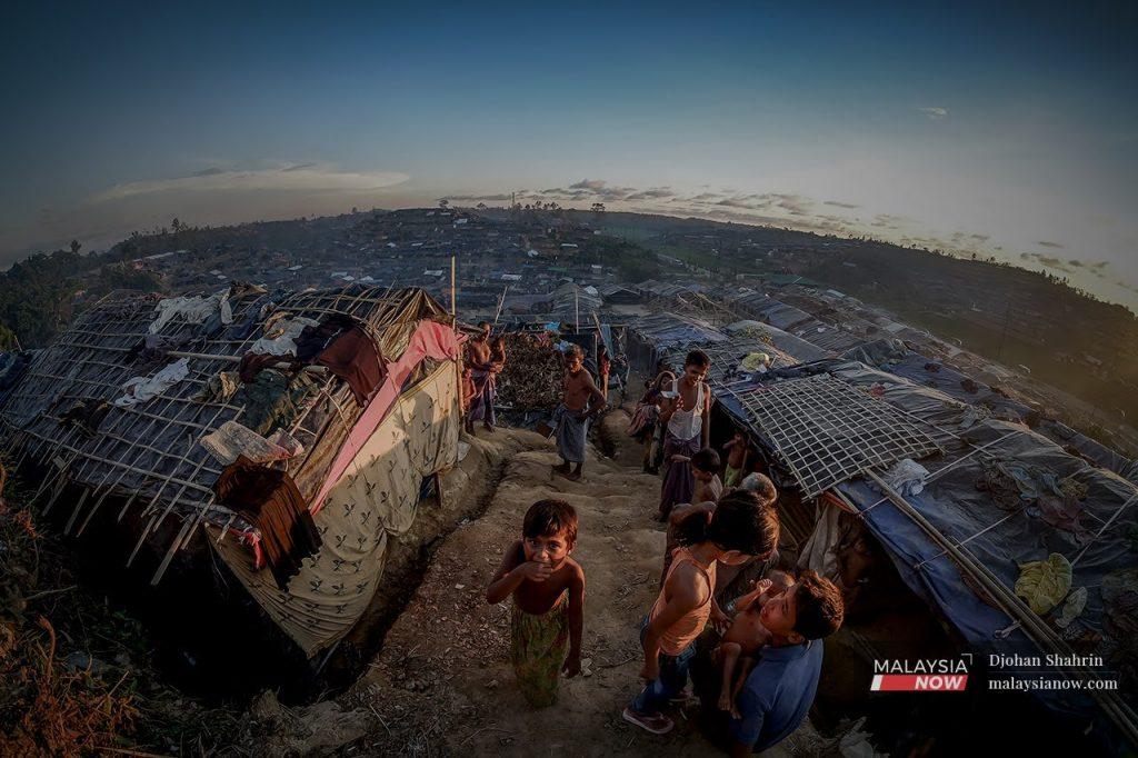 Rohingya children play outside temporary shelters at the Kutupalong refugee camp in Cox's Bazar, Bangladesh, in this file photo. Hundreds of thousands of Rohingya Muslims fled a military crackdown in Buddhist-majority Myanmar in 2017, bringing with them harrowing stories of murder, rape and arson.