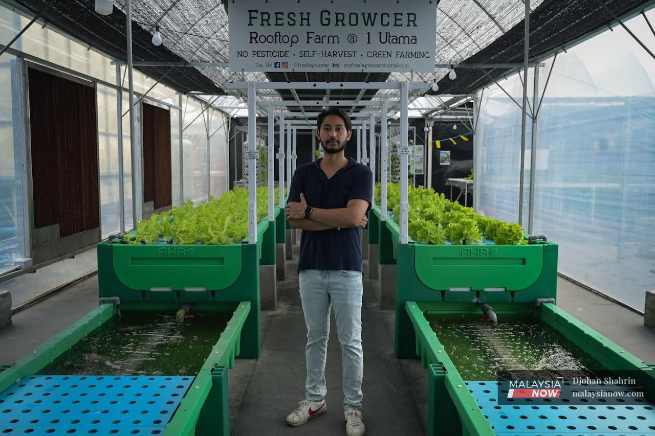Emil Jihad stands at the entrance of Fresh Growcer (Rooftop Farm @ 1Utama) in Petaling Jaya, the first aquaponics farm in the country to be started in a shopping mall.