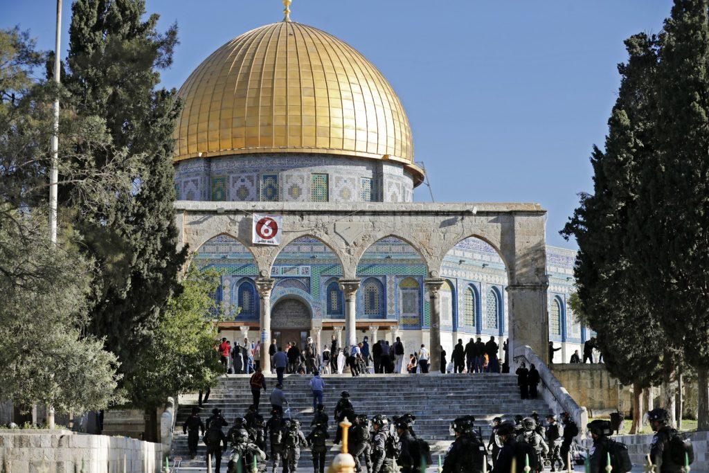 Israeli security forces patrol and Palestinians face each other in front of the Dome of the Rock mosque during clashes at Jerusalem's Al-Aqsa mosque compound, on April 15. Photo: AFP