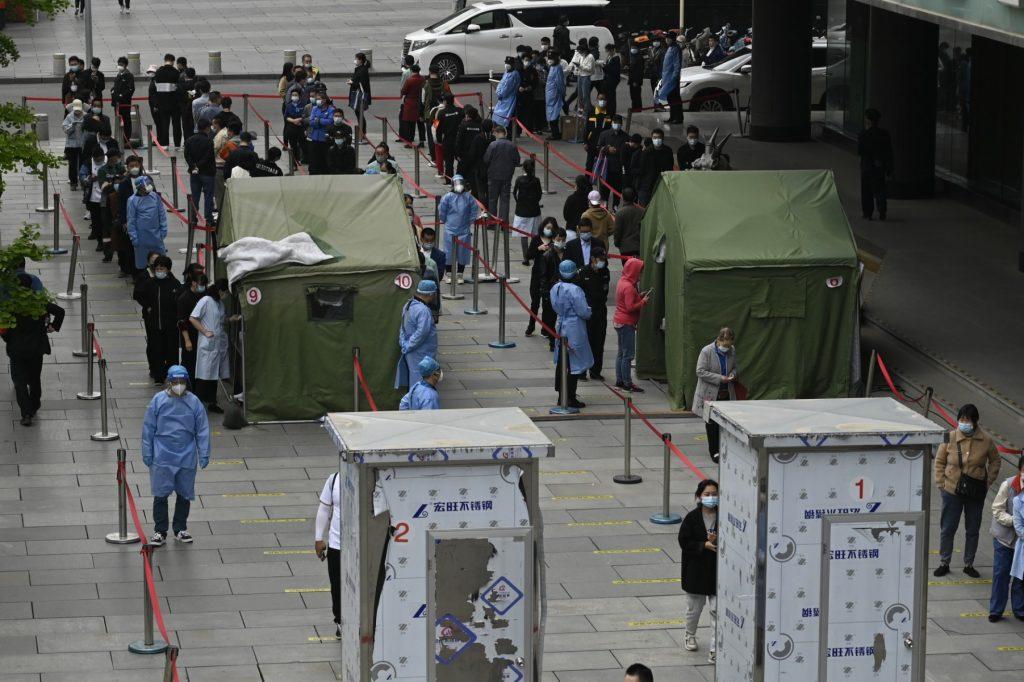 People line up at a Covid-19 testing site outside a shopping mall in Beijing on April 29. Photo: AFP