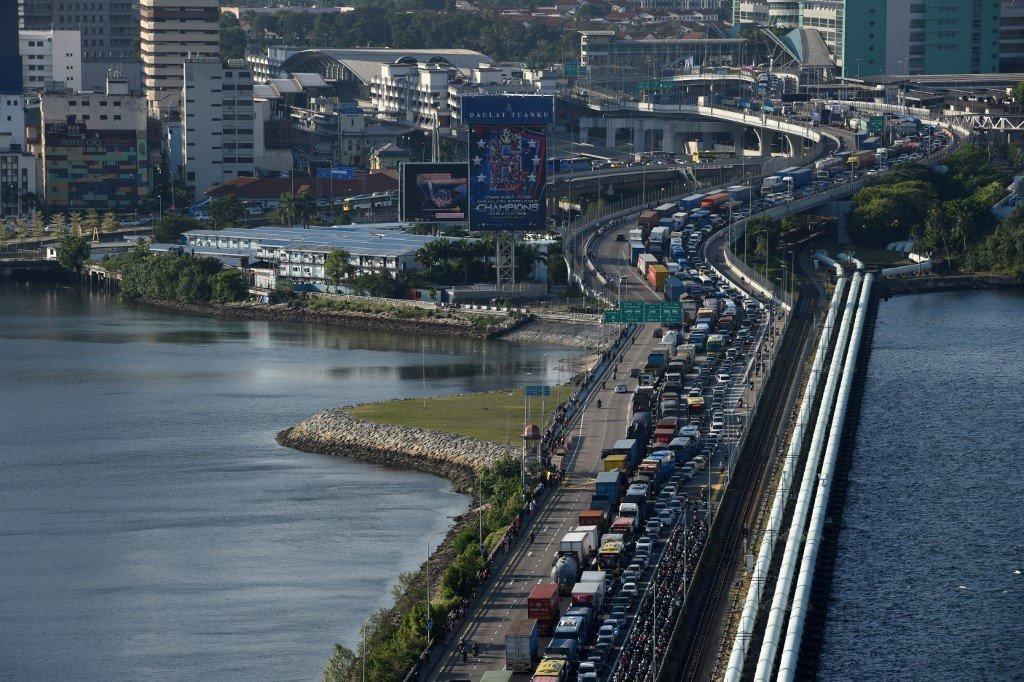 Vehicles queue to enter the Woodlands checkpoint in Singapore from the Johor causeway in this file photo. Photo: AFP