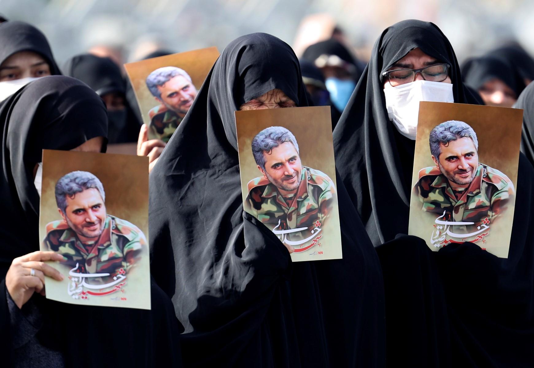 Iranian women lift portraits of Revolutionary Guards colonel Sayyad Khodai during his funeral procession at Imam Hussein square in the capital Tehran, on May 24. Photo: AFP