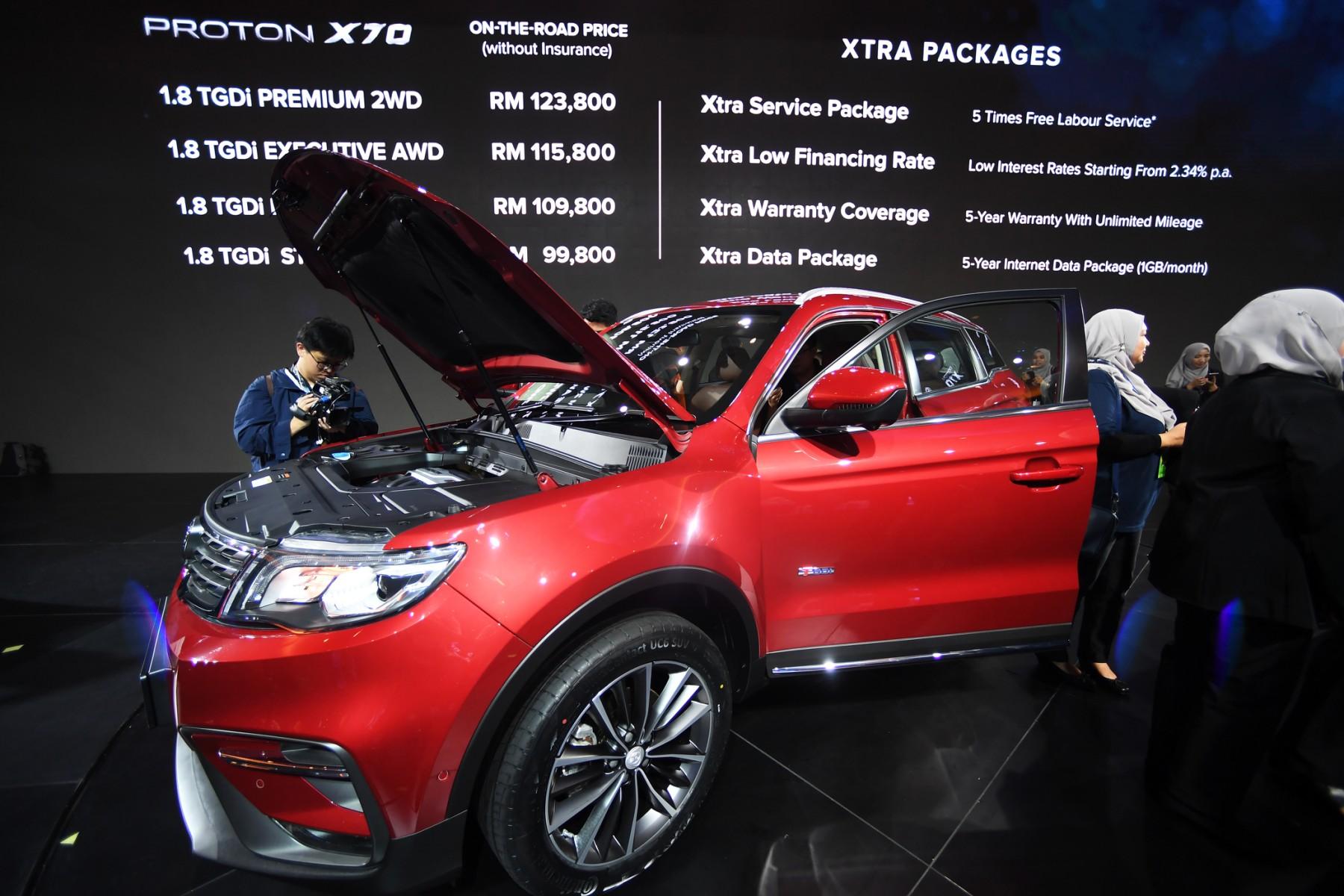People look at the 2019 Proton X70 SUV during the official launching ceremony in Kuala Lumpur on Dec 12, 2018. While Proton appears to have benefited from its partnership with Geely, automotive experts say there is more for the national carmaker to tap. Photo: AFP