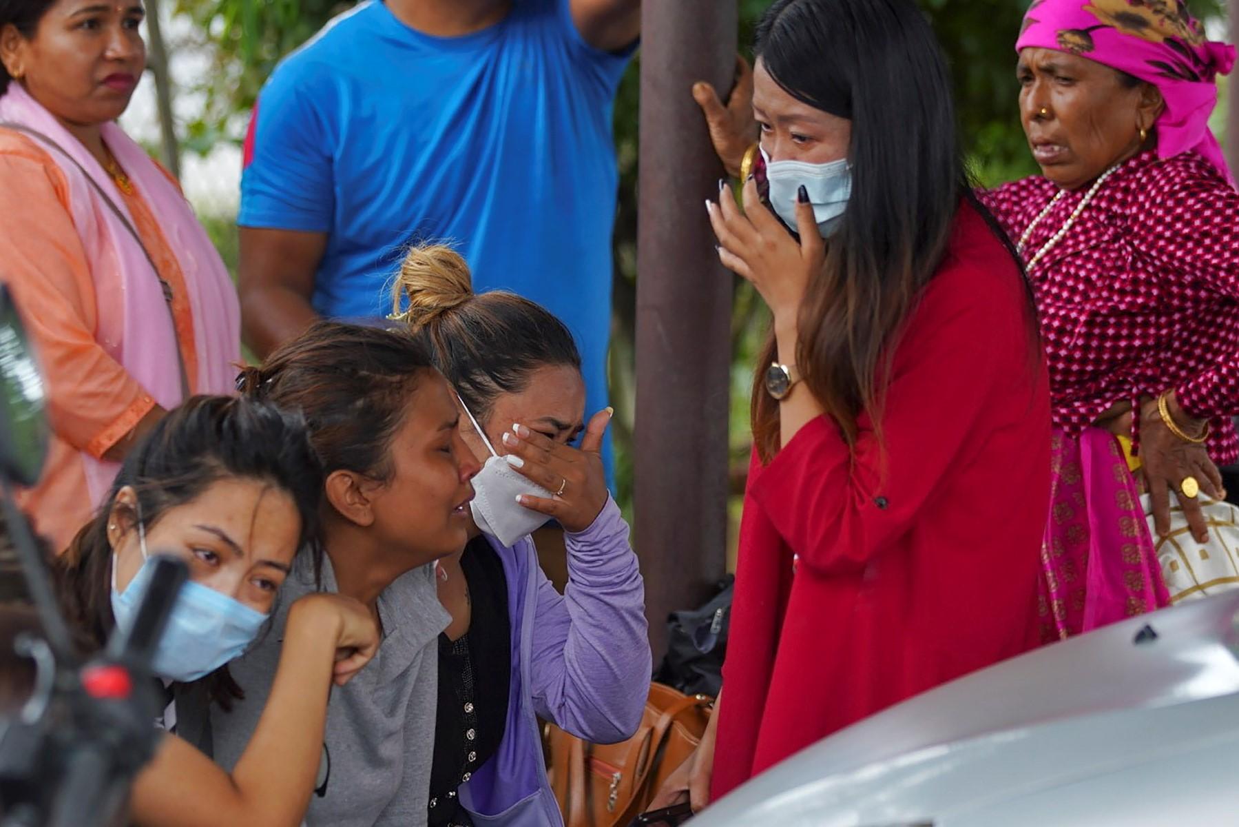 Family members and relatives of passengers on board the Twin Otter aircraft operated by Tara Air, weep outside the airport in Pokhara on May 29. Photo: AFP