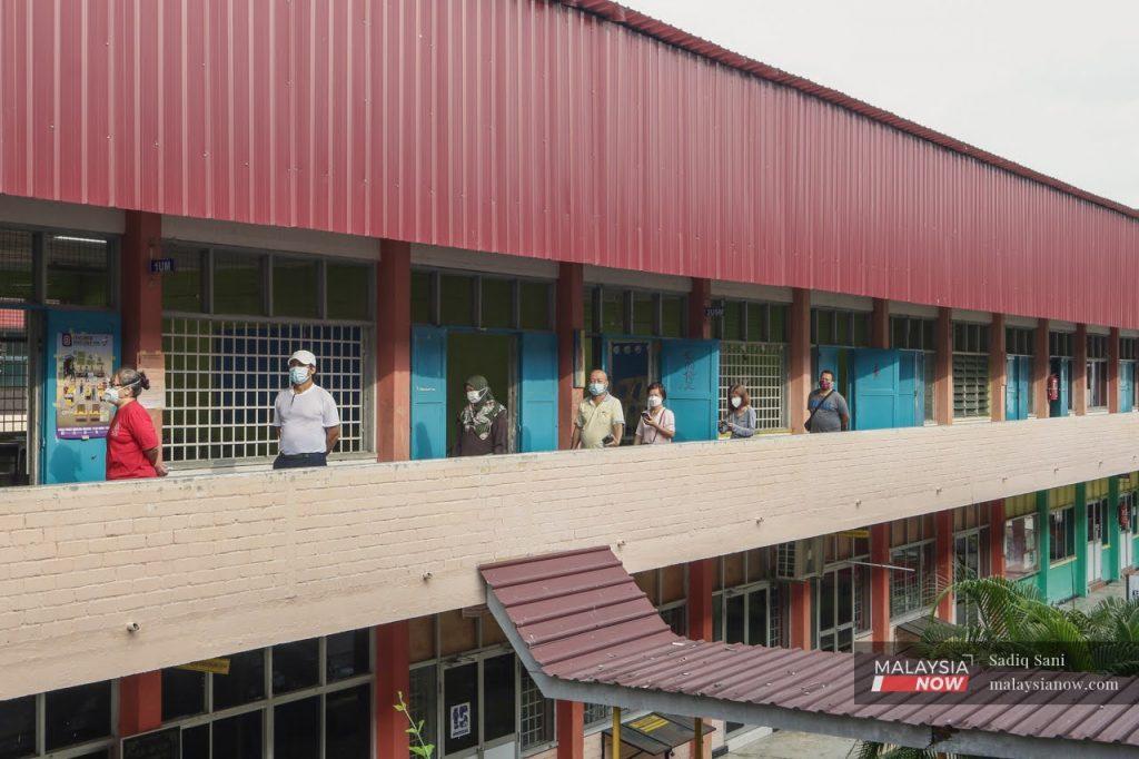 Voters queue to cast their ballots at a polling centre in Muar on election day in Johor in March. Prime Minister Ismail Sabri Yaakob says he will wait for 'the right time to call for an election' despite pressure from some in Umno to capitalise on the party's recent gains in state polls.