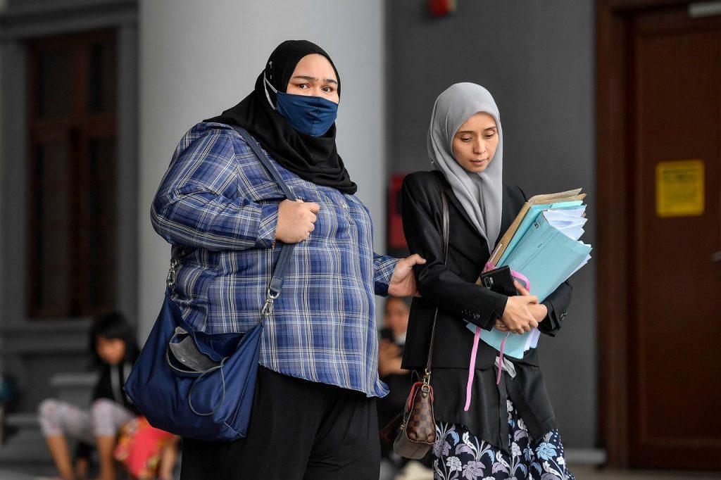 Rumah Bonda founder Siti Bainun Ahd Razali (left) arrives at the Kuala Lumpur court complex yesterday. Photo: Bernama