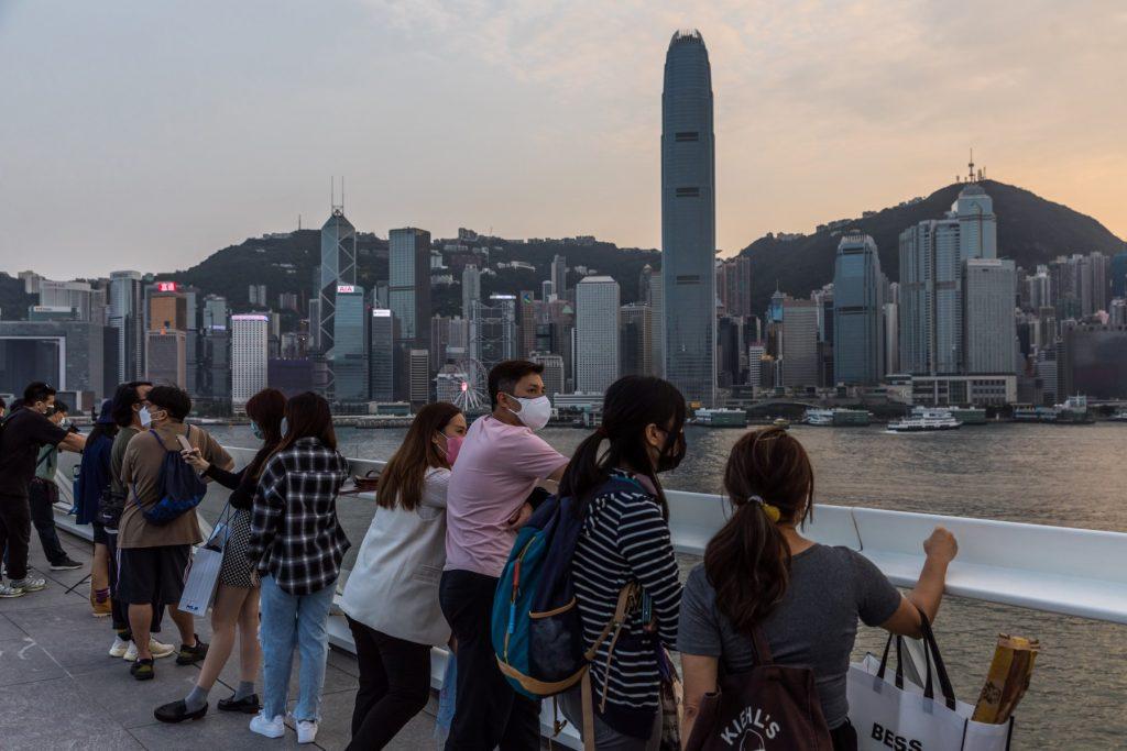 People visit a viewing deck next to Victoria Harbour in Hong Kong on April 13. Photo: AFP