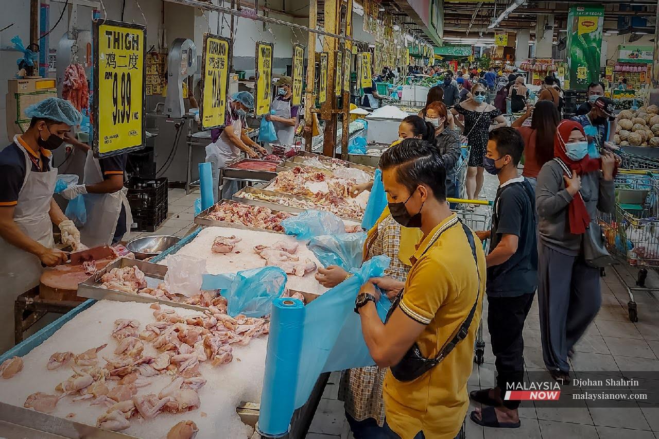 Shoppers queue to buy chicken at a supermarket in Taman Kuchai, Kuala Lumpur, in this file photo.