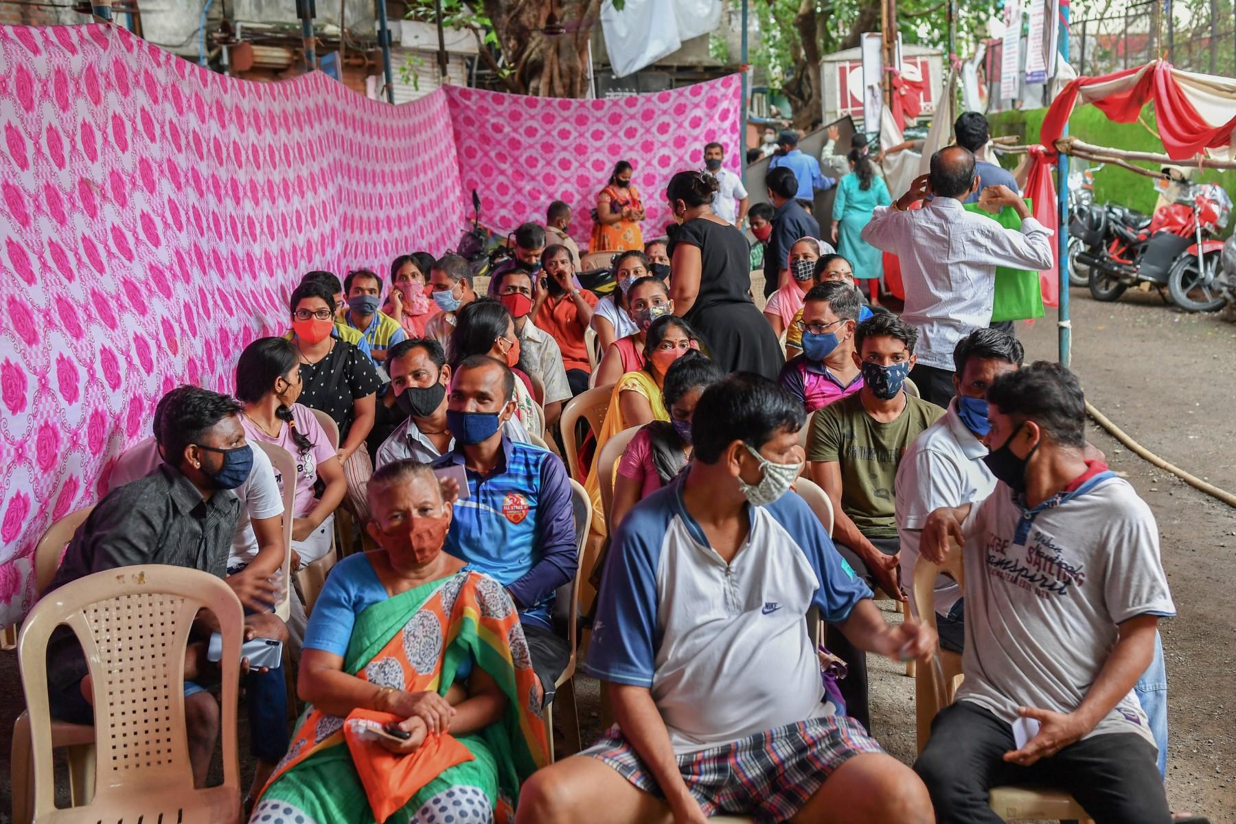 Residents await for the arrival of daily doses after a hiatus to get inoculated with a dose of the Covishield, AstraZeneca-Oxford's Covid-19 coronavirus vaccine, during a vaccination drive in Mumbai July 12, 2021. Photo: AFP