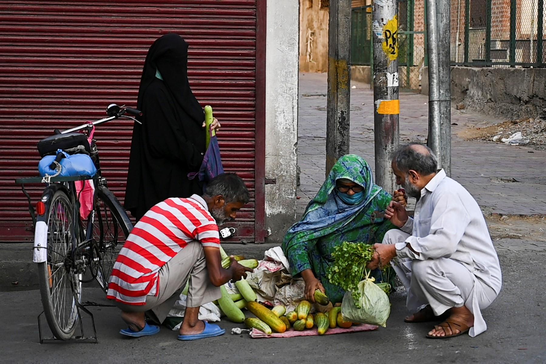 People buy vegetable before a curfew in Srinagar on Aug 4, 2020. Photo: AFP