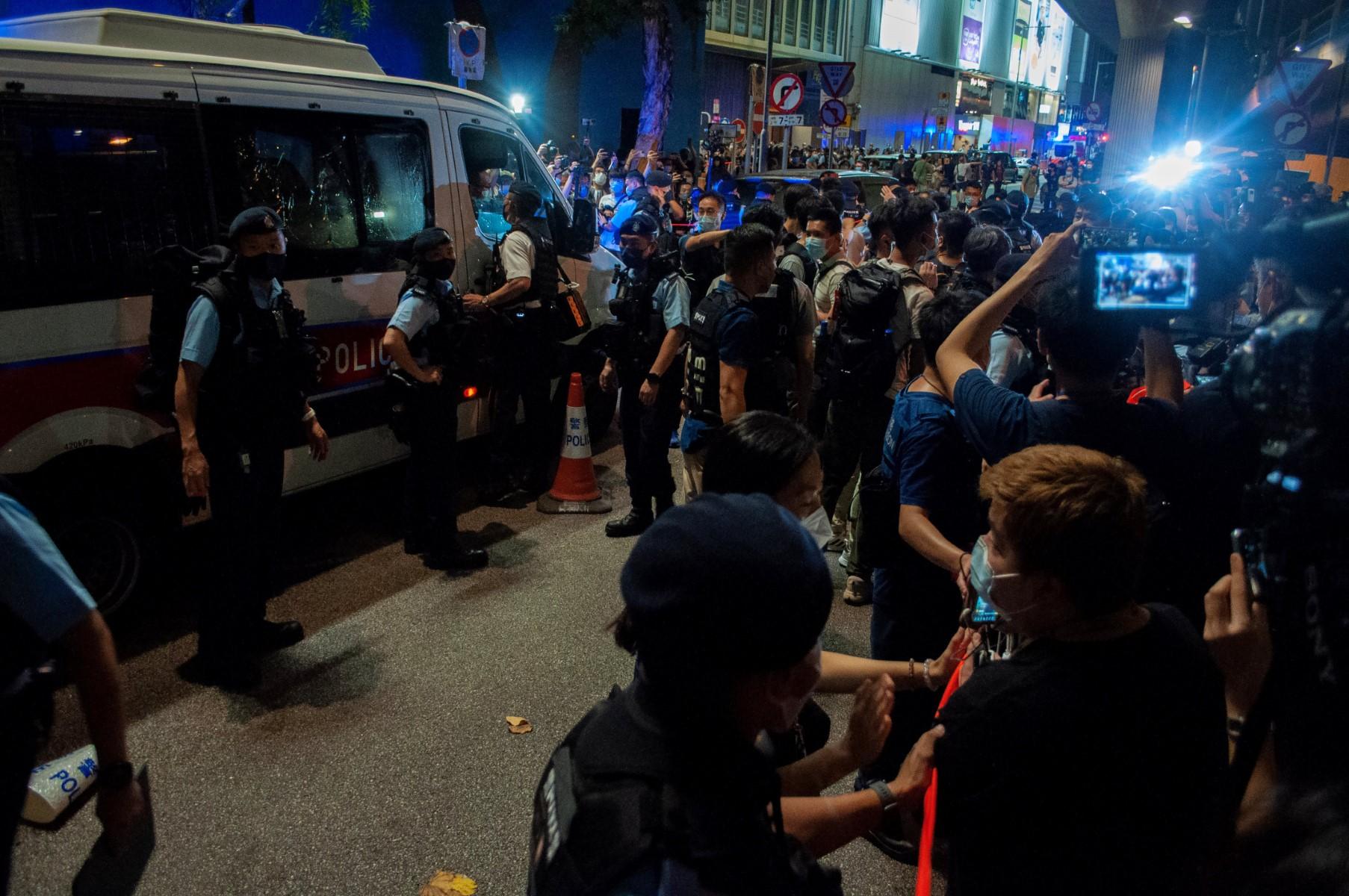 Police try to control the crowd in the Causeway Bay district of Hong Kong on June 4, near the venue where Hong Kong people have traditionally gathered to mourn victims of China's 1989 Tiananmen Square crackdown, on the 33rd anniversary of the event. Photo: AFP