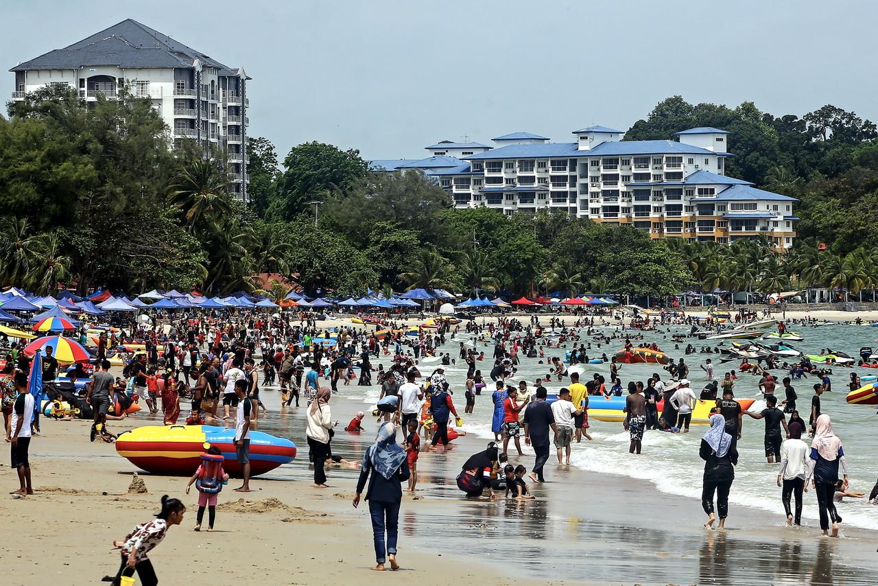 Families and friends spend the day at the beach at Pantai Telok Kemang in Port Dickson on June 5. Photo: Bernama