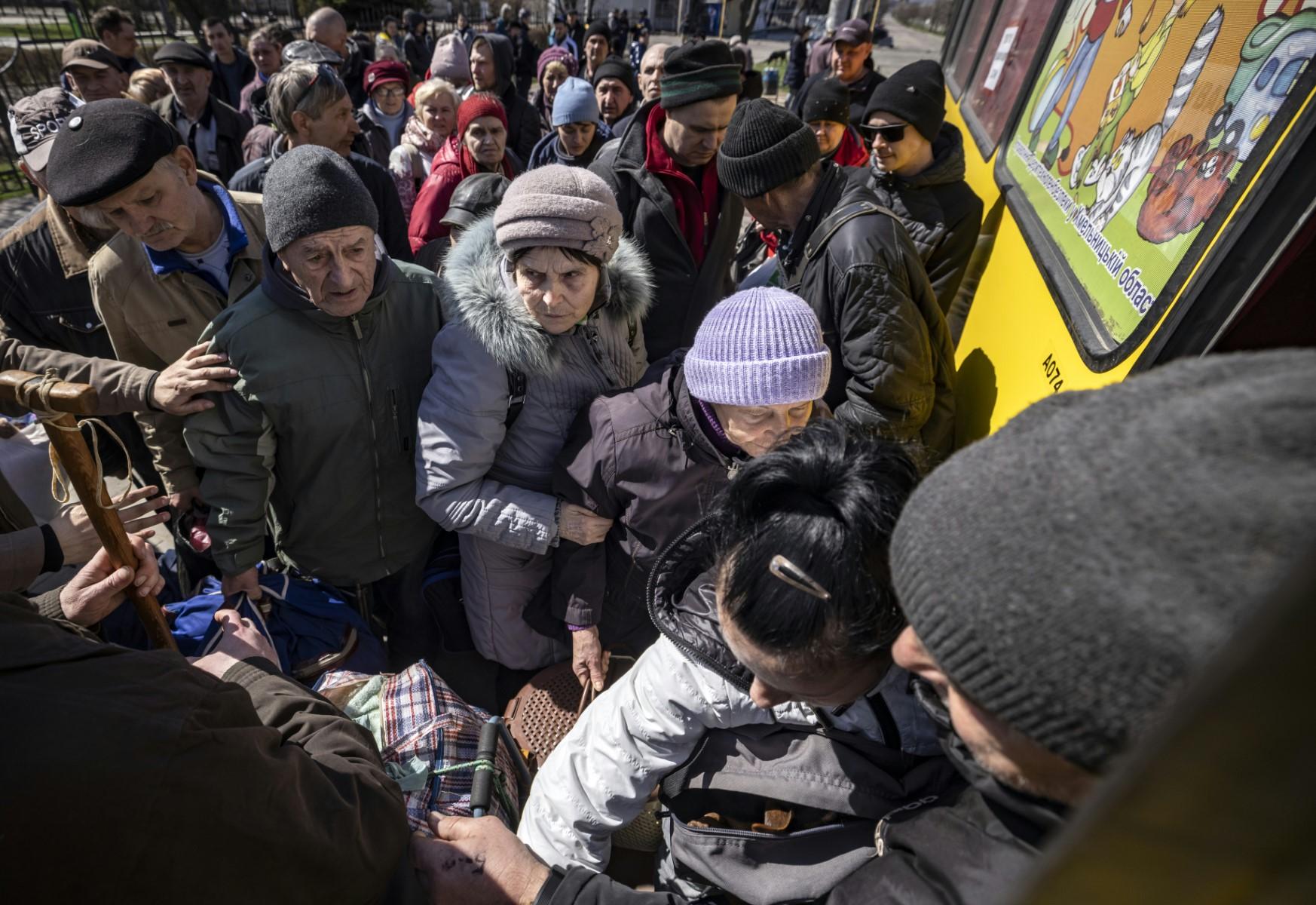 People wait for a bus at a train station in Severodonetsk, eastern Ukraine, on April 7, as they flee the city in the Donbas region. Photo: AFP