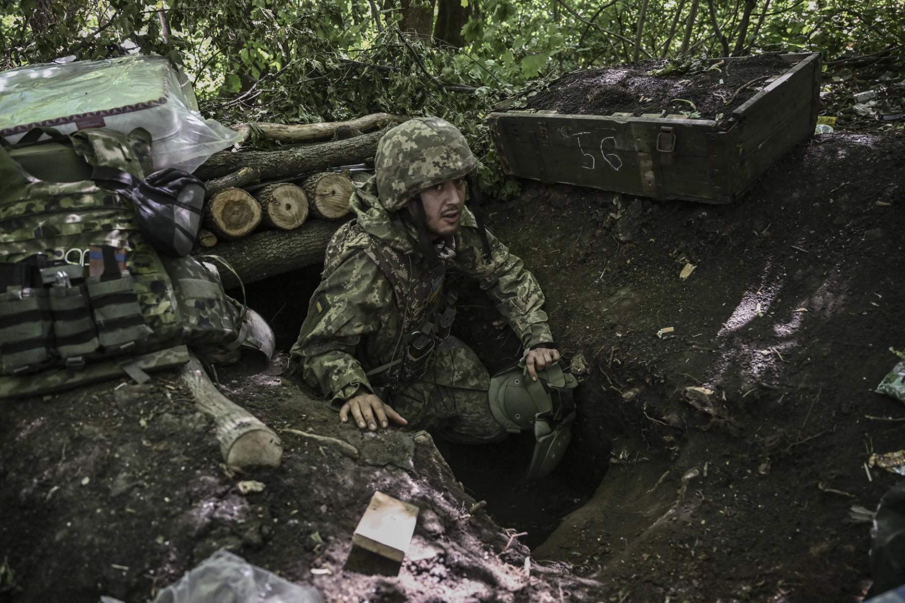 A Ukrainian serviceman gets out of an underground makeshift bunker after a shelling at a field camp near the front line at an undisclosed location in the eastern Ukrainian region of Donbas on June 6. Photo: AFP