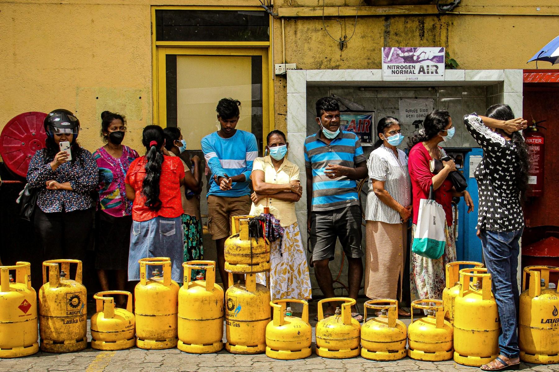 People queue up to buy liquefied petroleum gas cylinders in Colombo on June 5. Months of daily blackouts, long queues for petrol and record inflation have made daily life a misery in the South Asian island nation of 22 million people. Photo: AFP