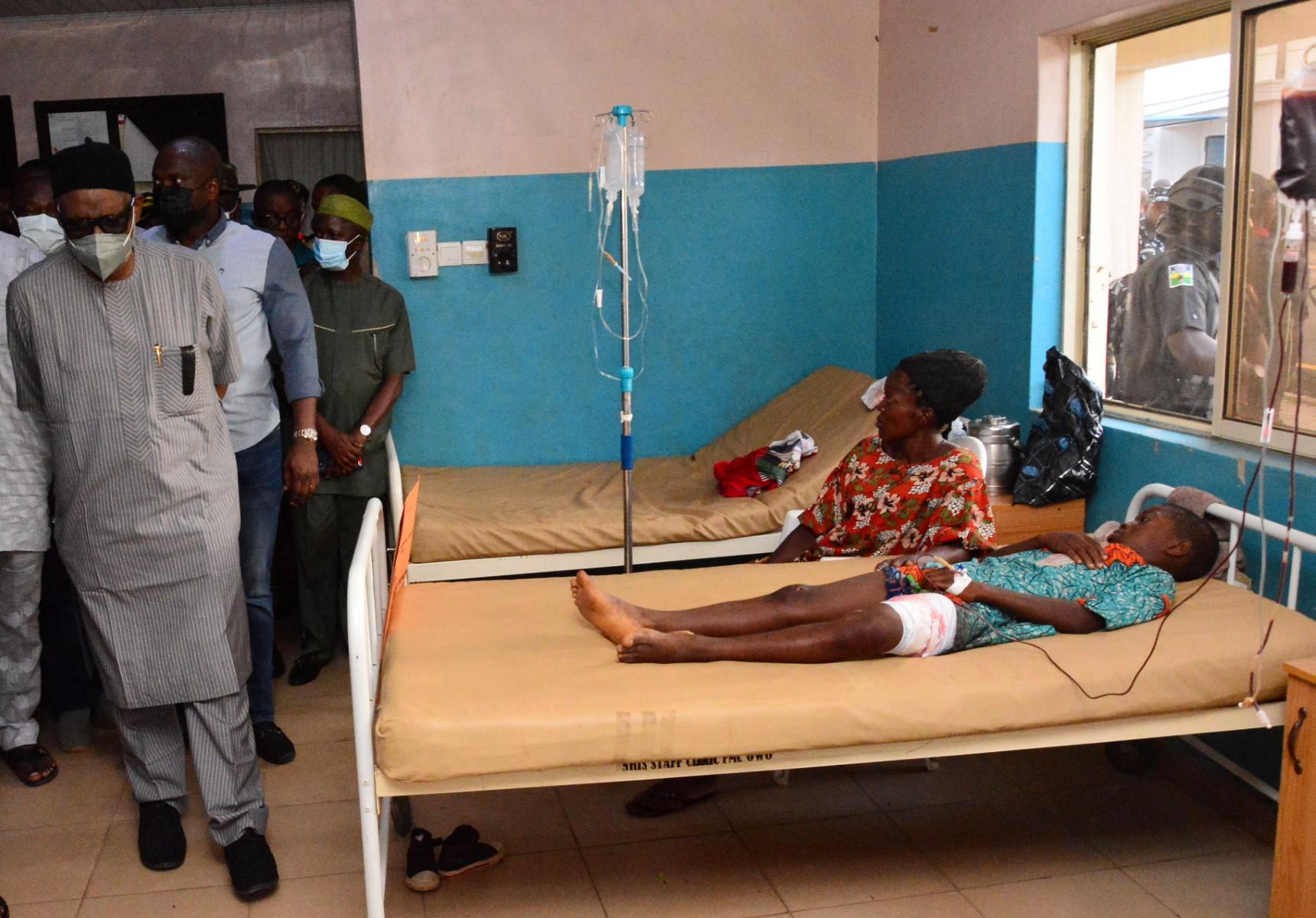 State officials walk past injured victims on hospital beds being treated for wounds following an attack by gunmen at St Francis Catholic Church in Owo town, southwest Nigeria on June 5. Photo: AFP