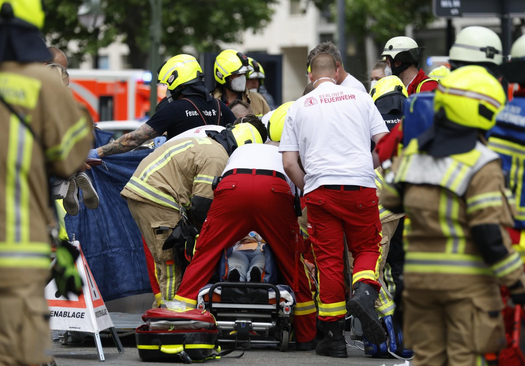 Rescue workers help an injured person at the site where one person was killed and eight injured when a car drove into a group of people in central Berlin, on June 8. Photo: AFP