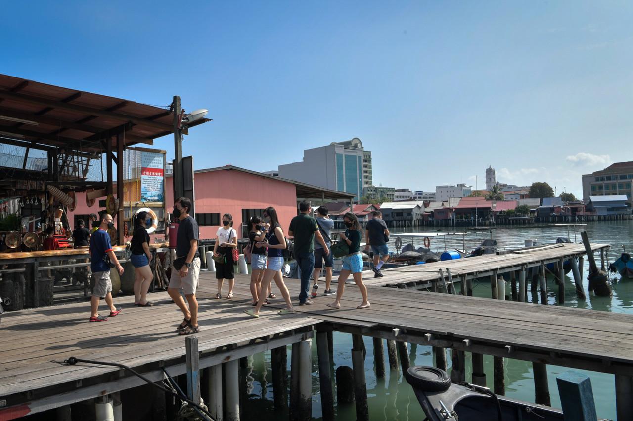 Visitors stroll about at the Chew Jetty in George Town, Penang. Photo: Bernama