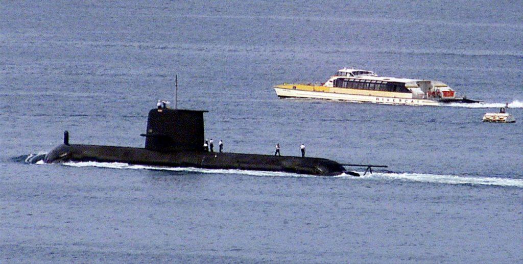 A ferry passes by the Royal Australian Navy's Collins-class submarine HMAS Waller as it leaves Sydney Harbour in this file photo on May 4, 2020. Photo: Reuters