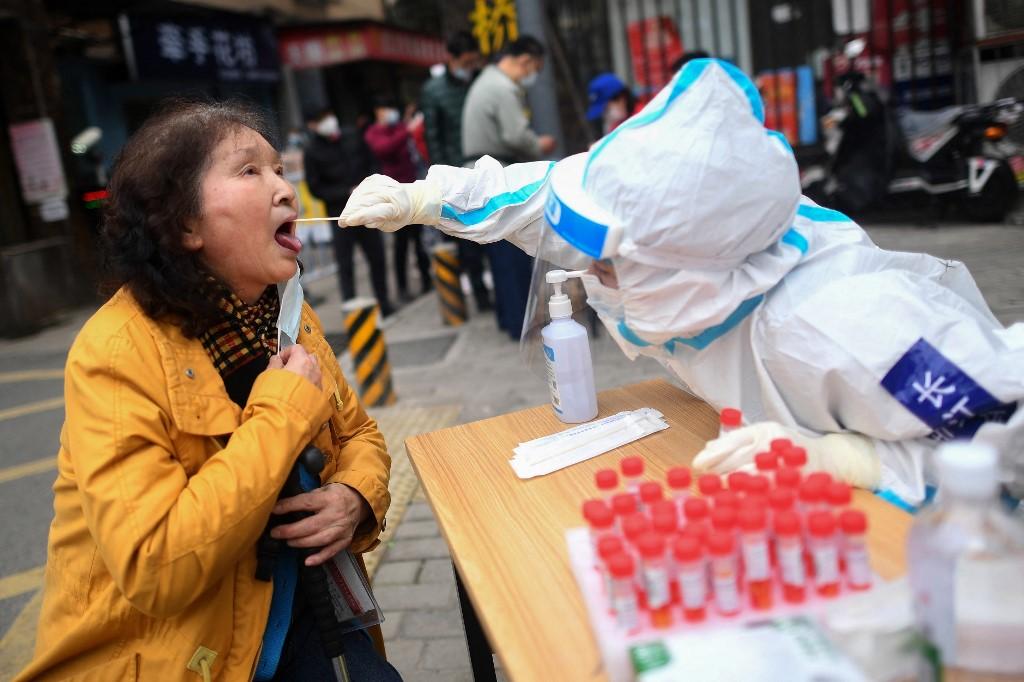 This photo taken on March 6 shows a resident undergoing a nucleic acid test for Covid-19 in Wuhan in China's central Hubei province. Photo: AFP