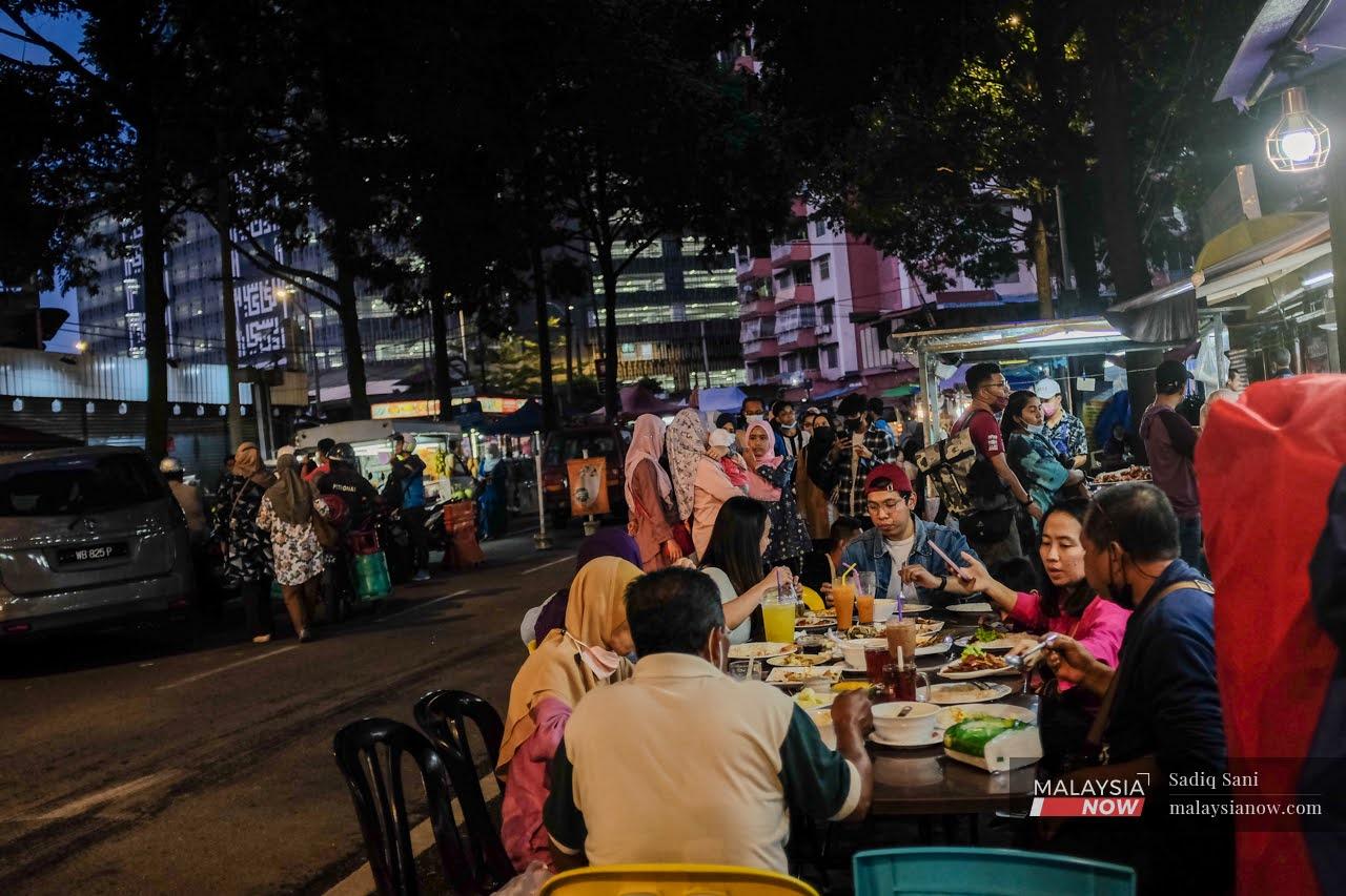 Families enjoy their dinner at a restaurant in Kampung Baru, Kuala Lumpur.