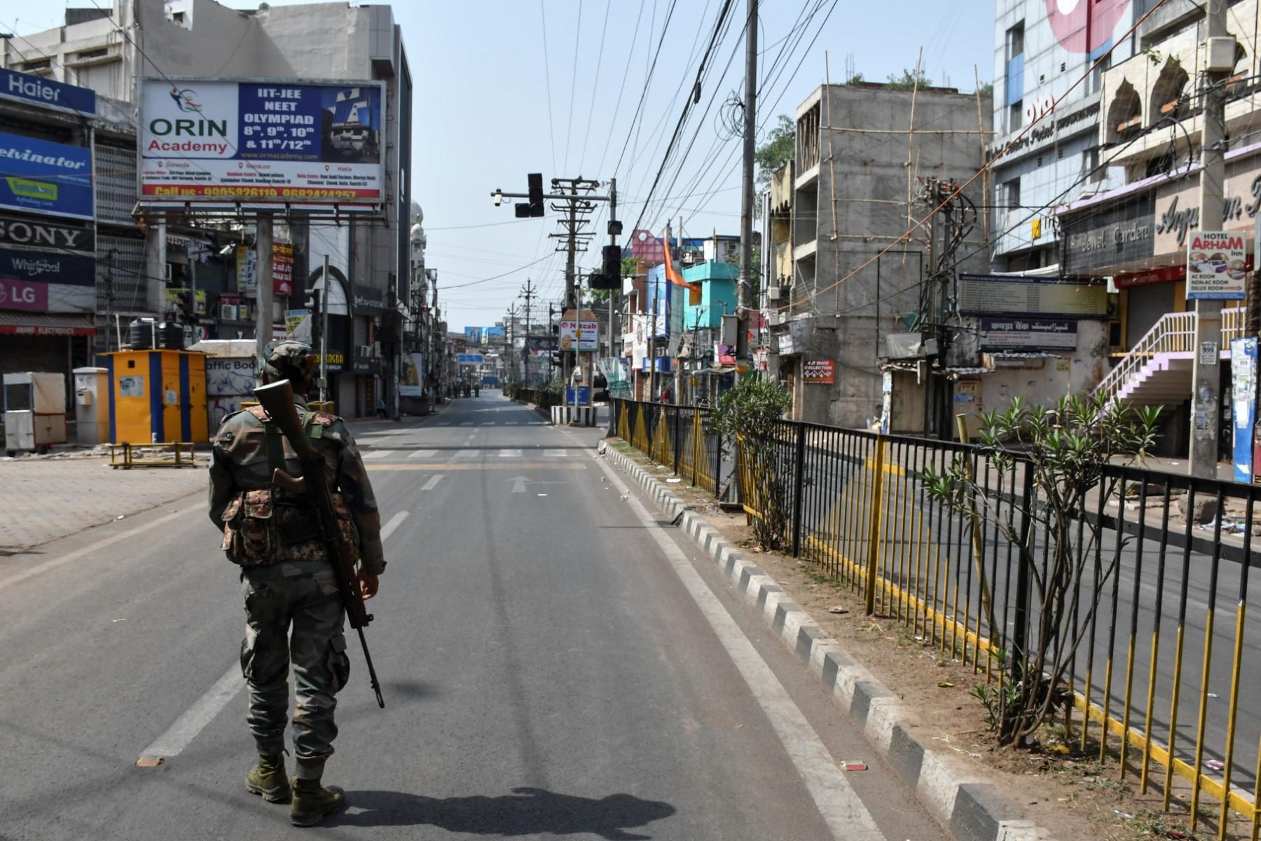A security personnel patrols a deserted road during a partial curfew imposed following violent demonstrations against former Bharatiya Janata Party spokesman Nupur Sharma's remarks on the Prophet Muhammad, in Ranchi on June 11. Photo: AFP