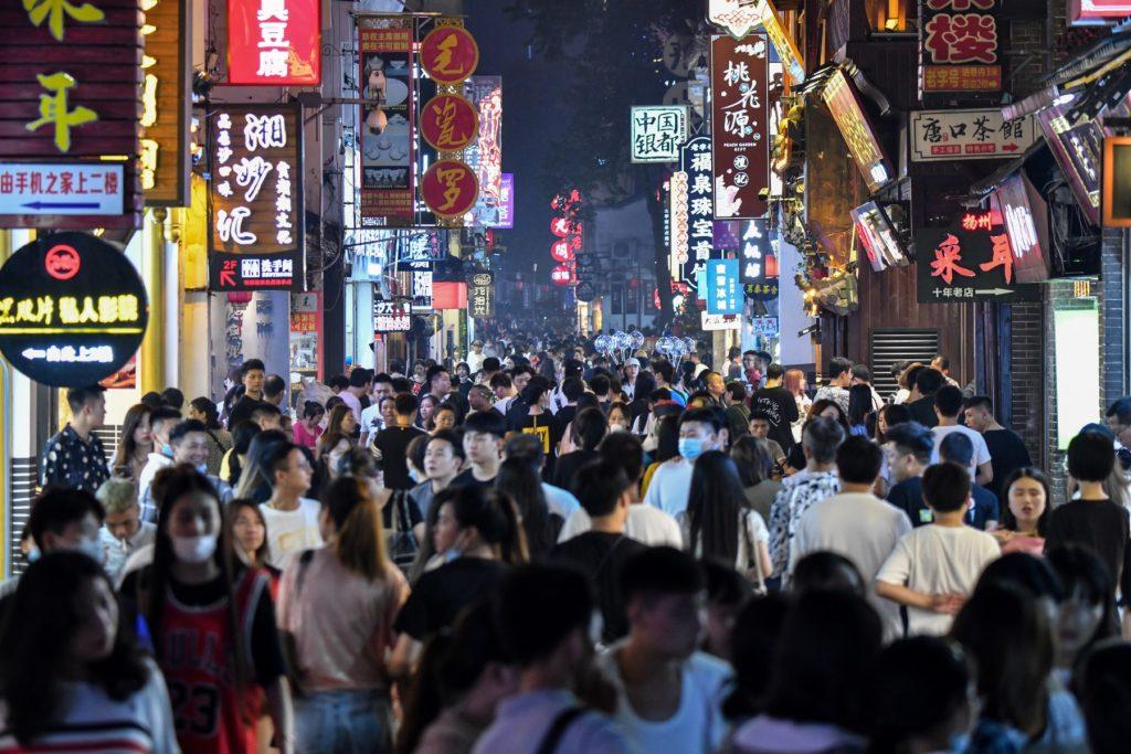 People walk along a pedestrian street surrounded by small shops in the city of Changsha, China's Hunan province, on Sep 7, 2020. Photo: AFP