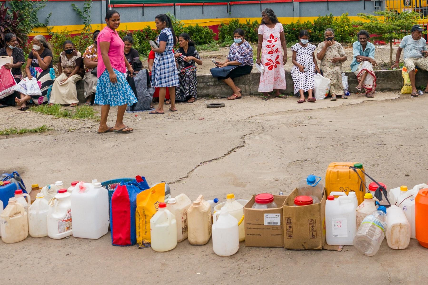 People queue up to buy kerosene for domestic use at a supply station in Colombo on June 17. Photo: AFP