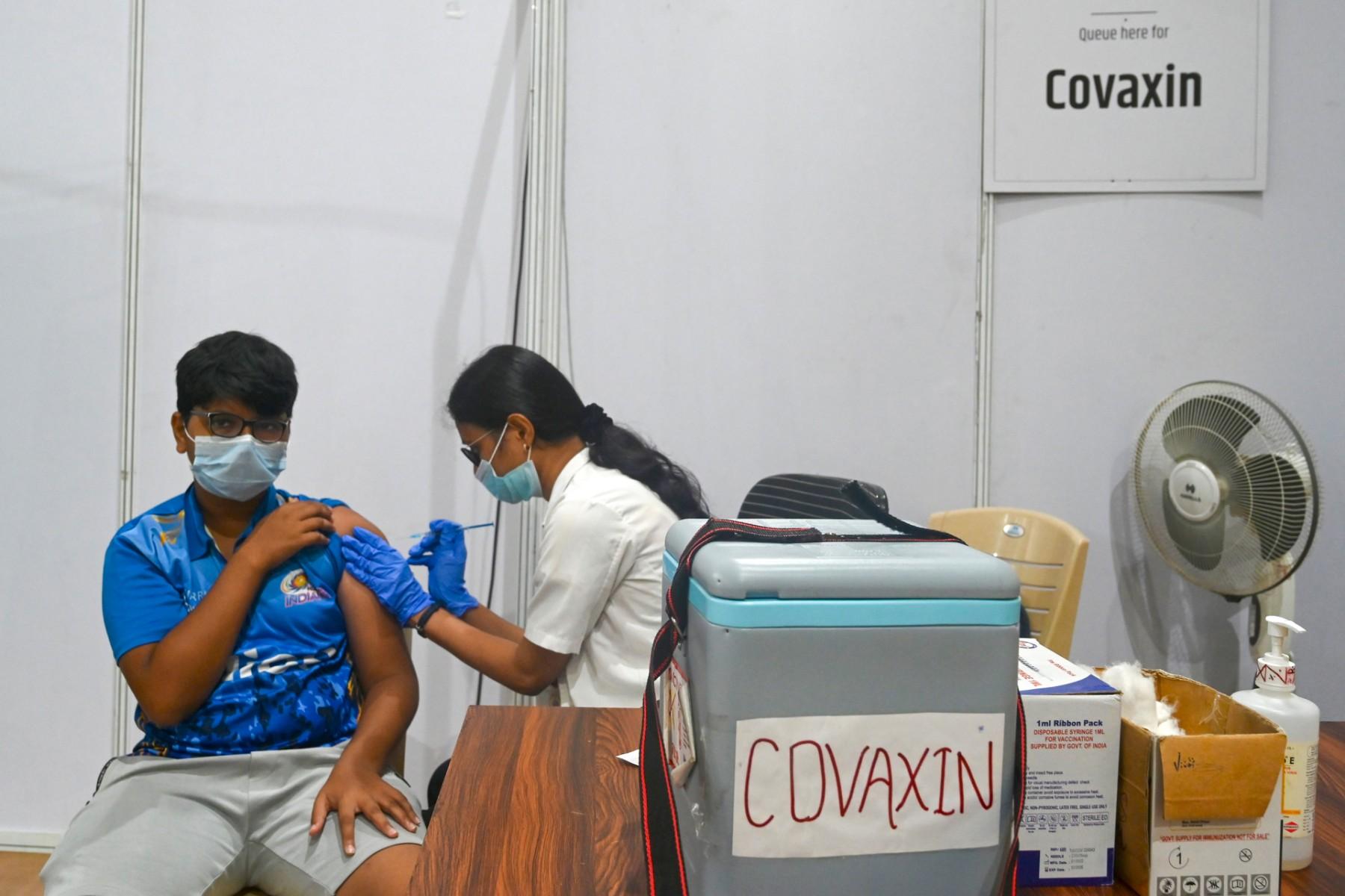 A health worker inoculates a teenage boy with a dose of the Covaxin vaccine against Covid-19 at a vaccination centre in Mumbai on June 9. Photo: AFP