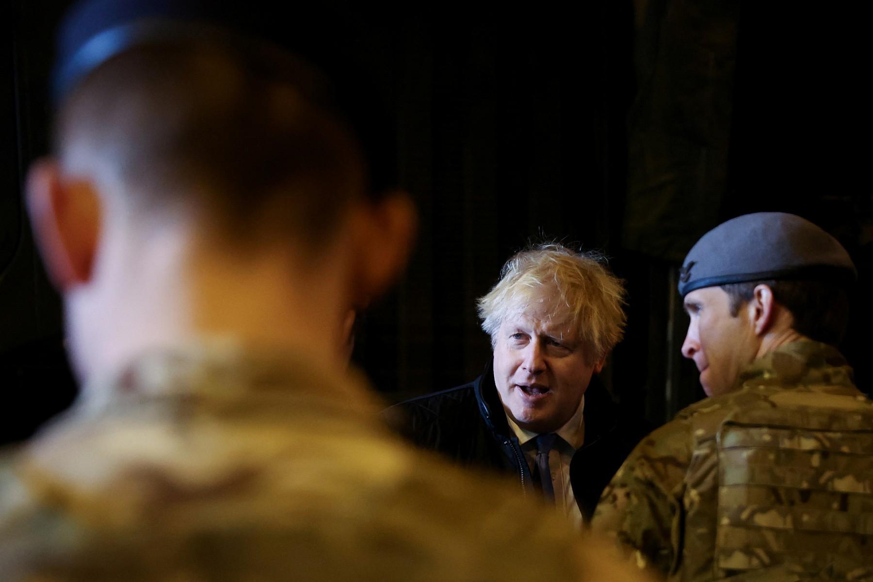 British Prime Minister Boris Johnson speaks with troops during a visit to the Royal Air Force Station in Waddington, Lincolnshire, on Feb 17. Photo: AFP