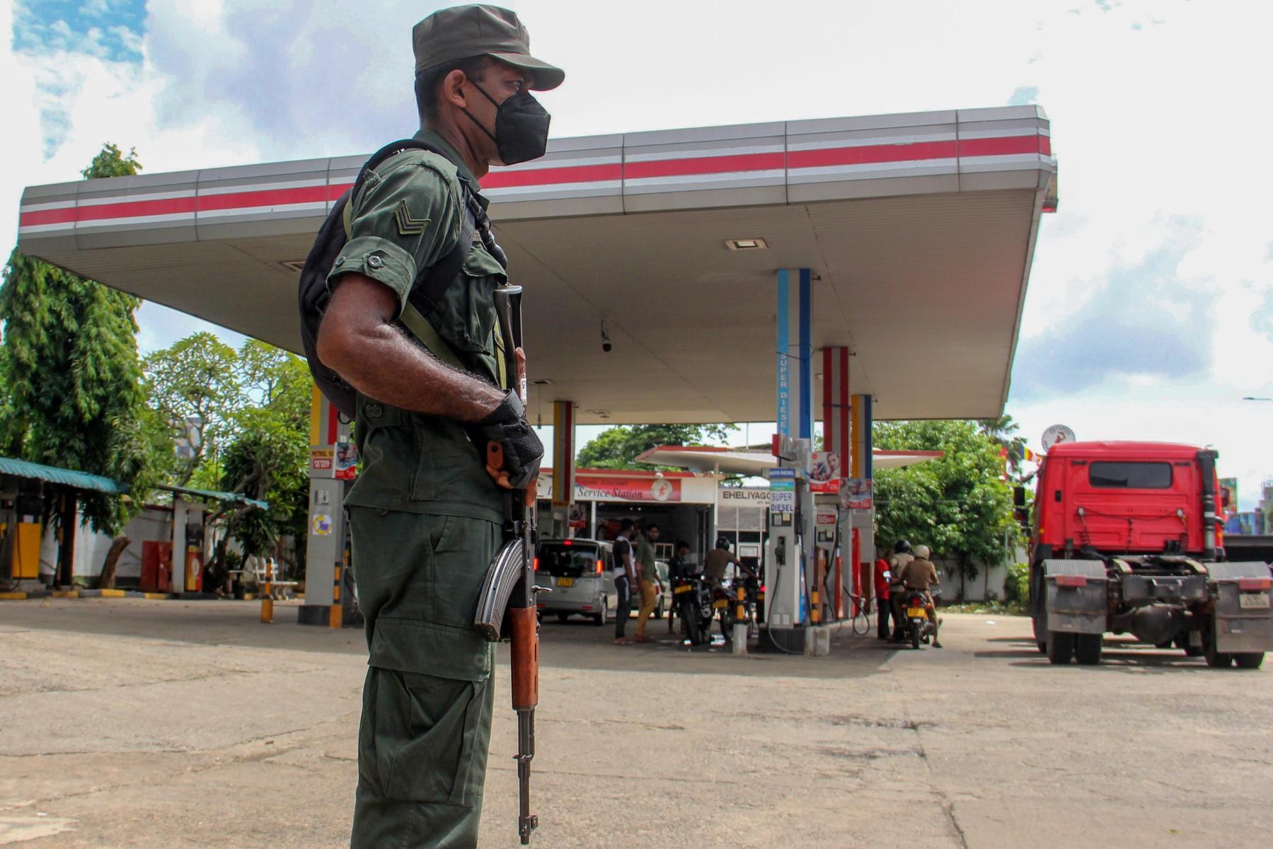 A member of Sri Lankan security personnel stands guard at a Ceylon Petroleum Corporation fuel station in Colombo on June 19. Photo: AFP