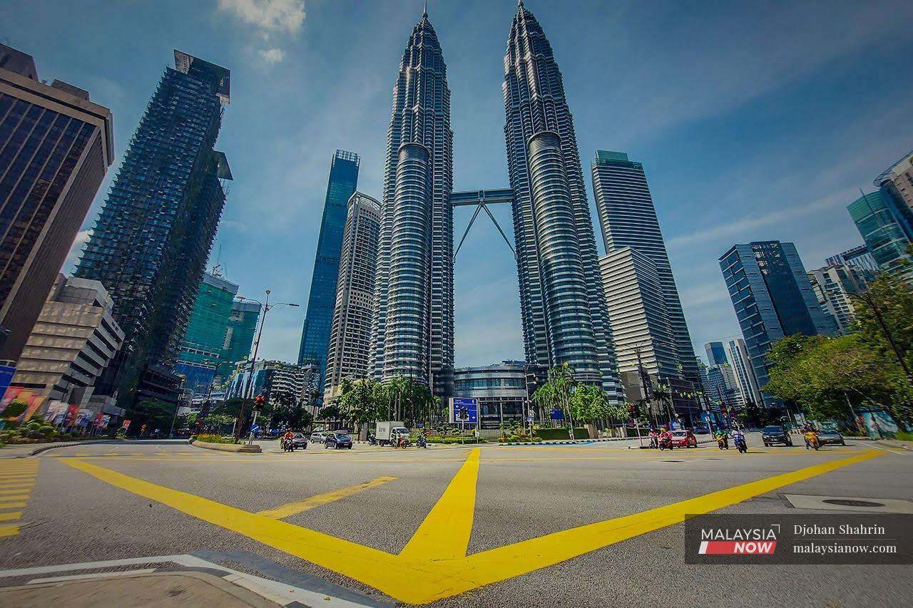 Motorists wait at the traffic light of a junction near KLCC in the capital city of Kuala Lumpur.