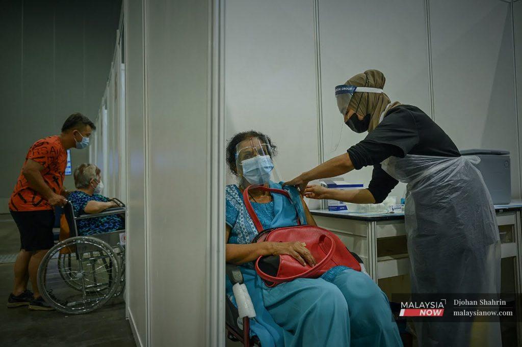 A health worker administers a shot of Sinovac Covid-19 vaccine to a senior citizen at the Mitec vaccination centre in Jalan Dutamas, Kuala Lumpur, in this file picture taken June 9, 2021.