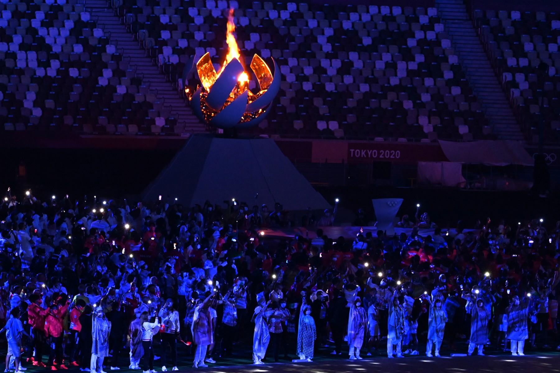 Athletes gather next to the Olympic Cauldron during the closing ceremony of the Tokyo 2020 Olympic Games, at the Olympic Stadium, in Tokyo, on Aug 8, 2021. Photo: AFP